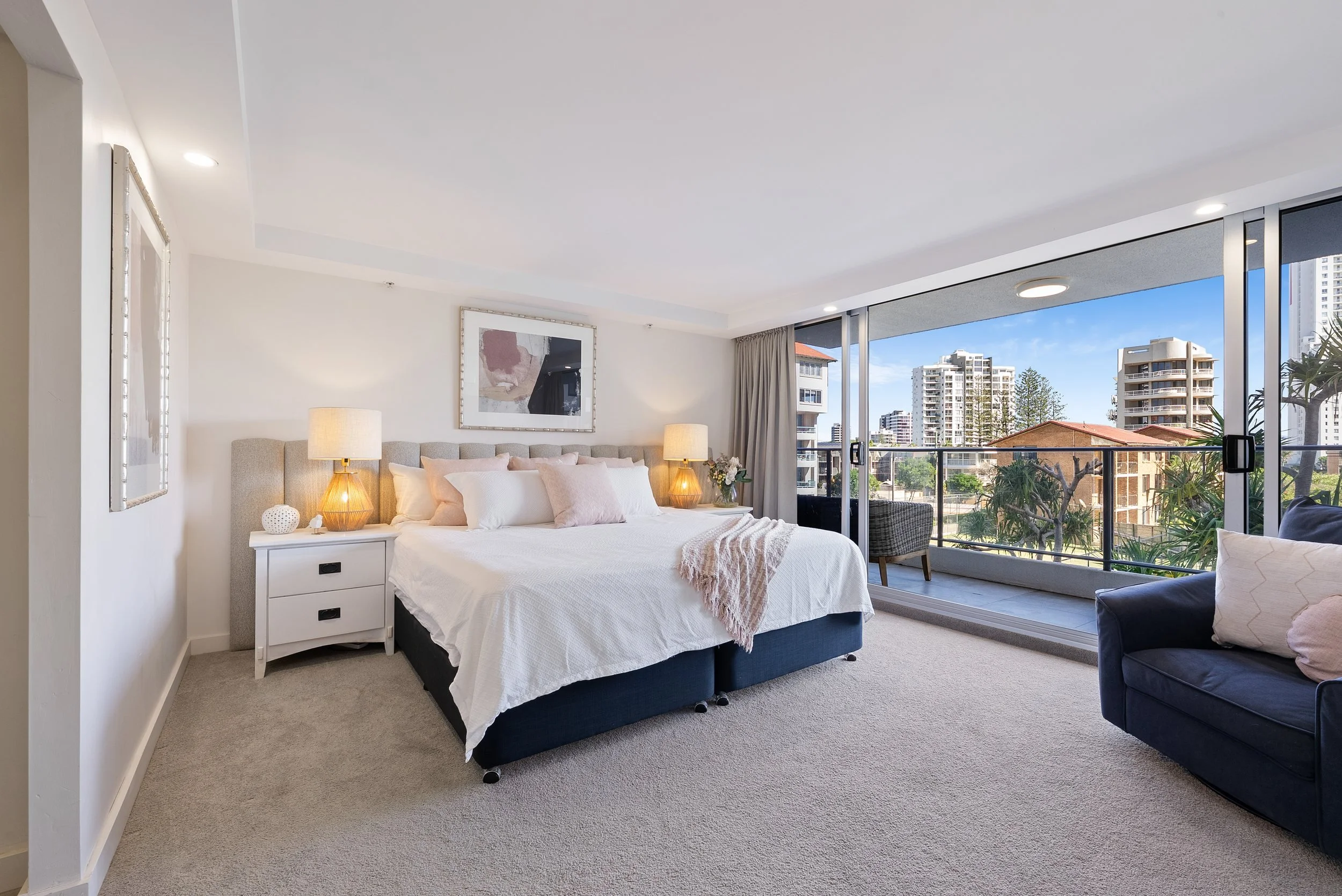 Bedroom with large bed and balcony access