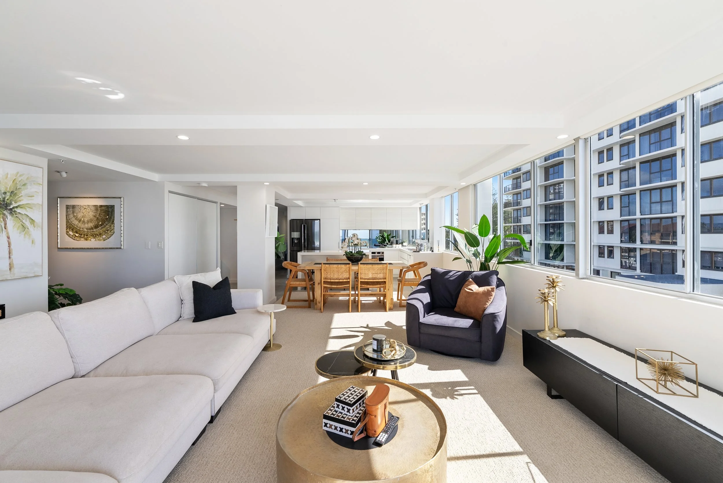 Living and dining area with large sofa and large windows