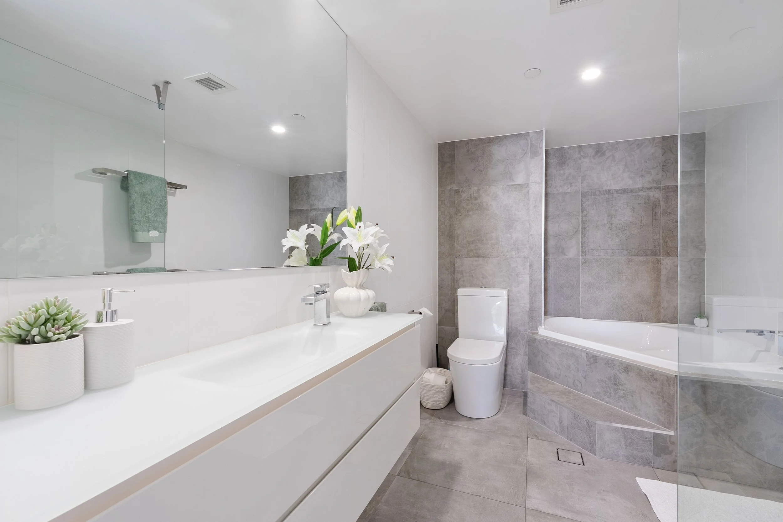 Bathroom with vanity and corner bath