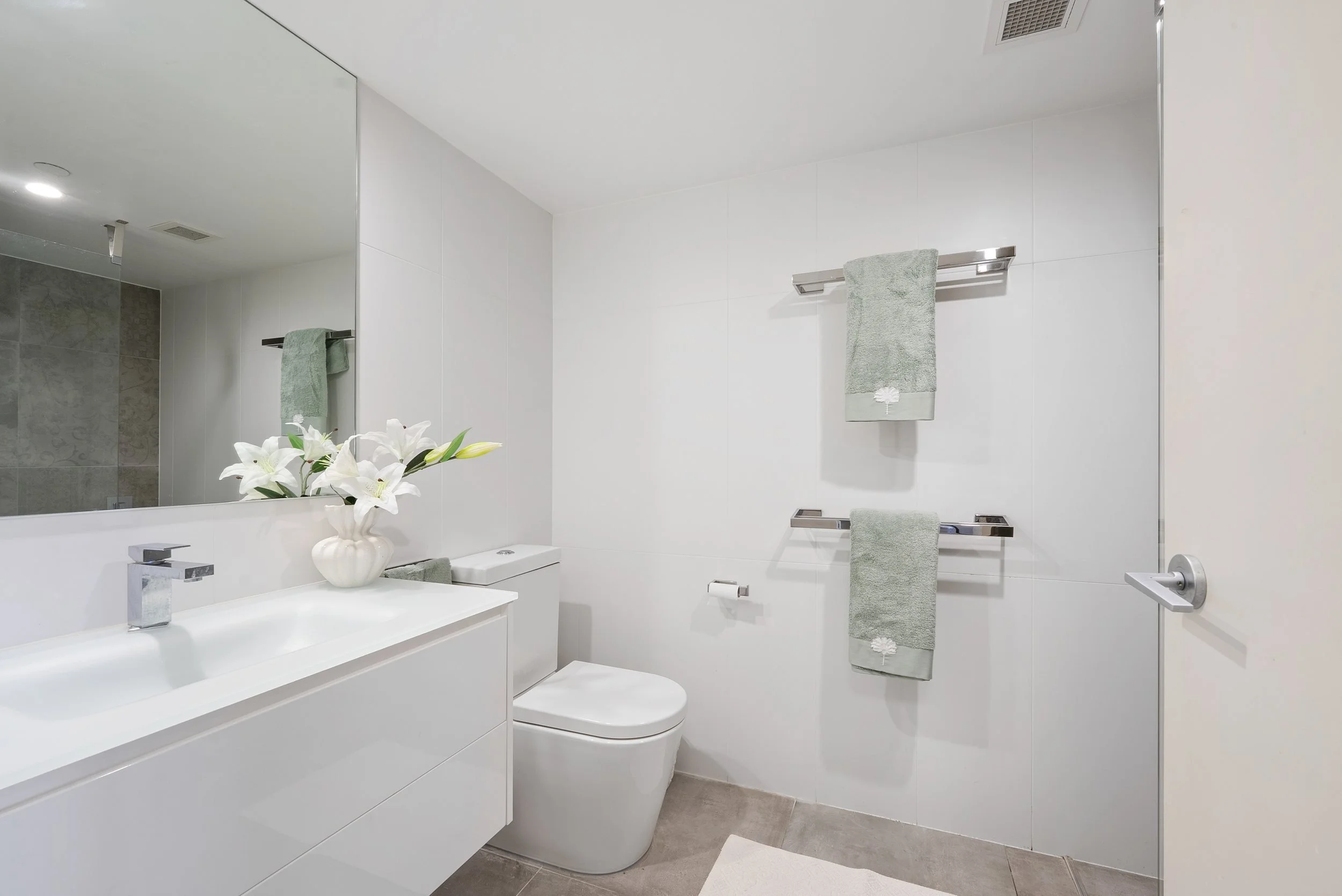 Bathroom with vanity, toilet and towels