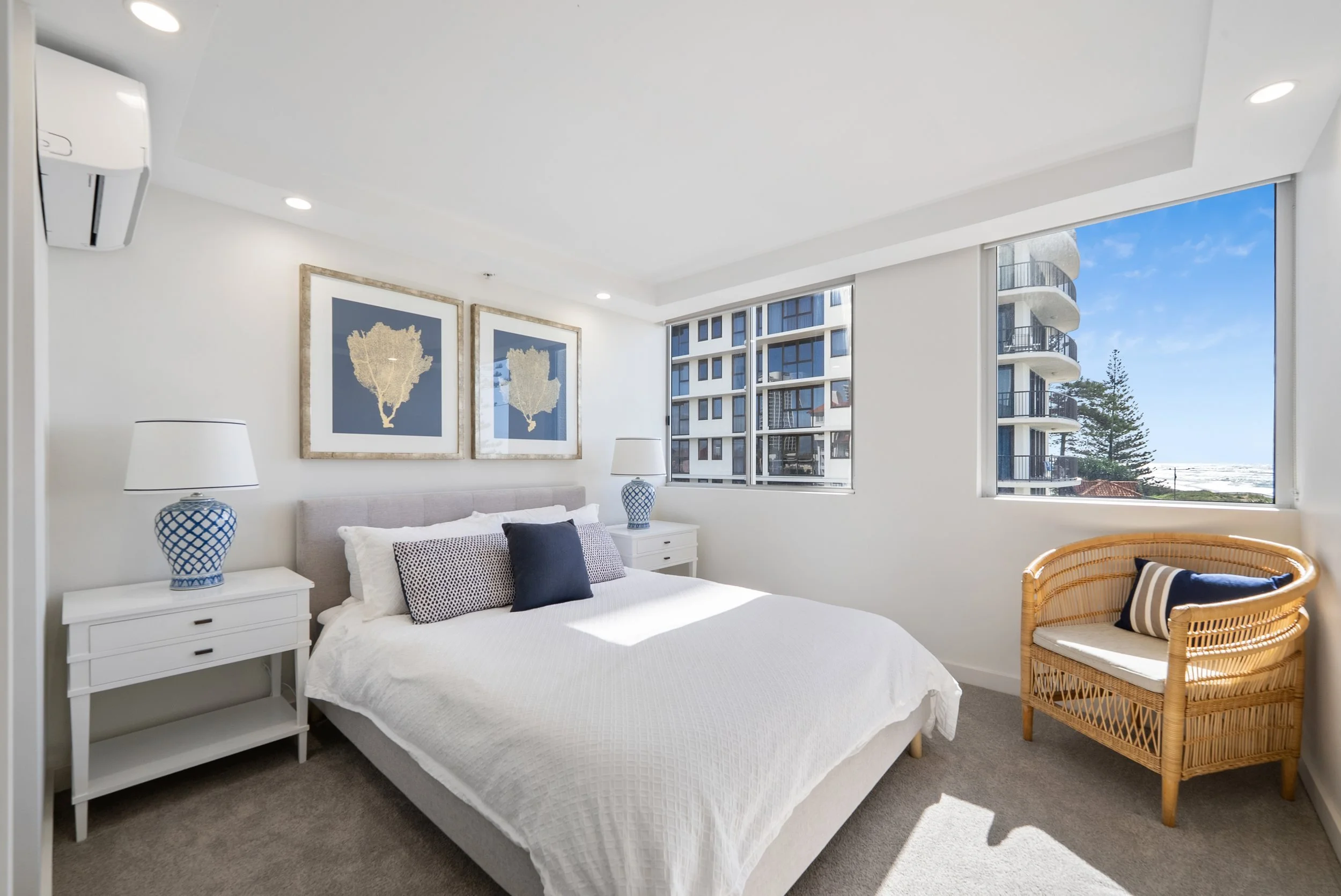 Bedroom with bed, framed artwork and window