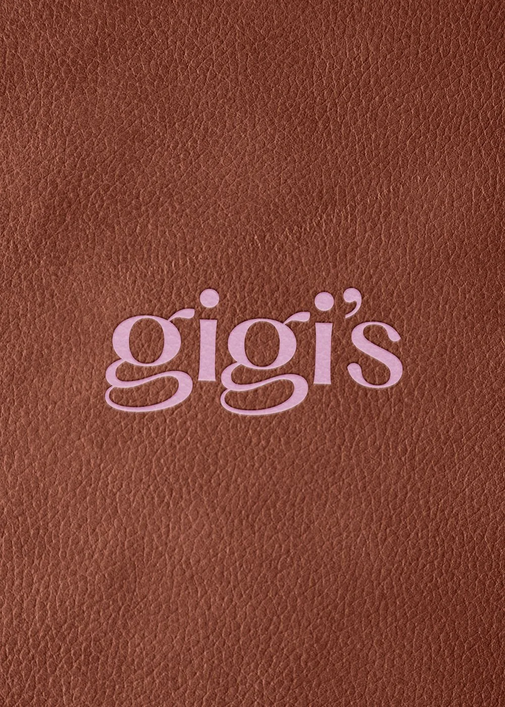 The word “gigi’s” in pink lettering on a textured brown leather background