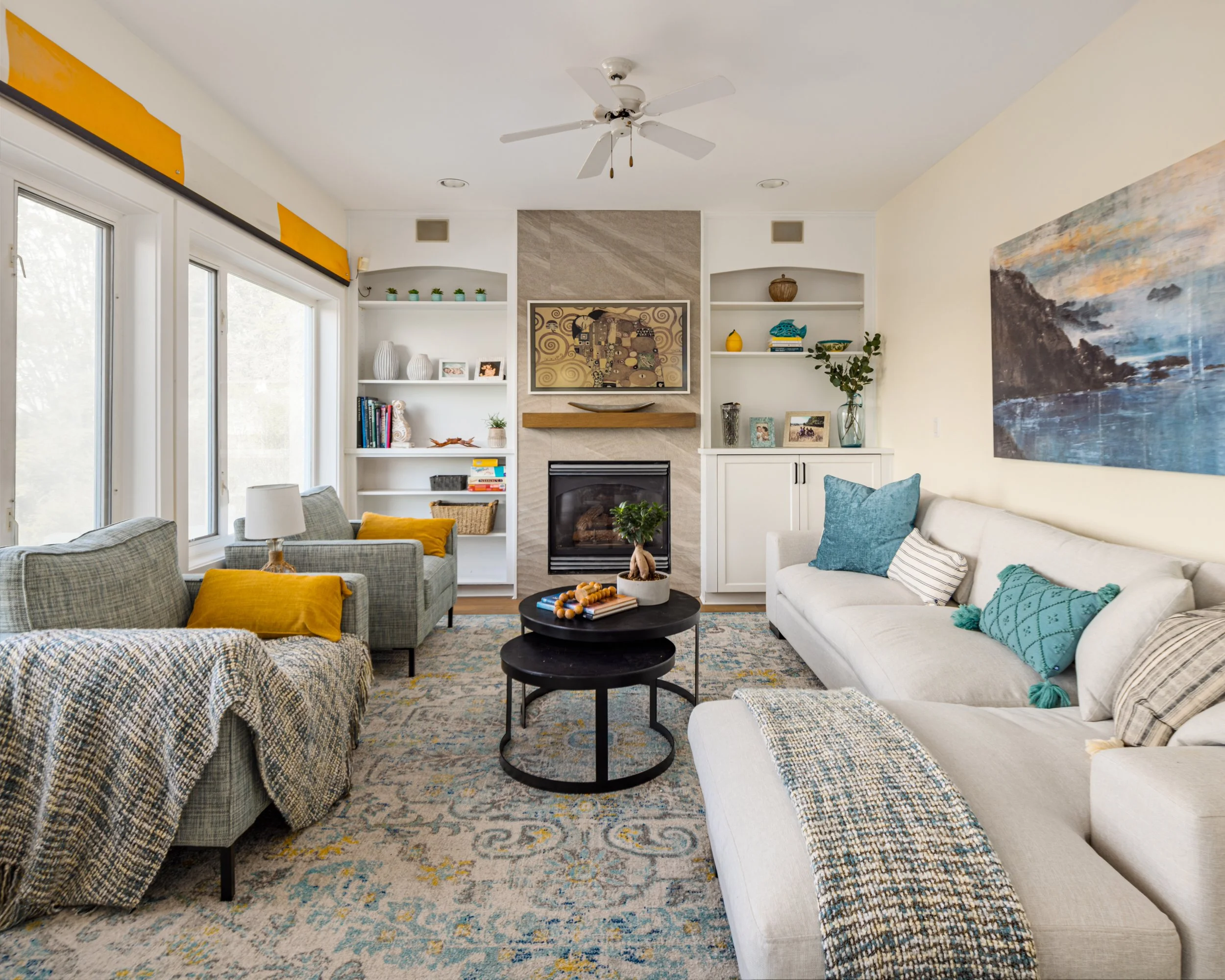 Inviting residential living room with fireplace, built-in shelving and natural light