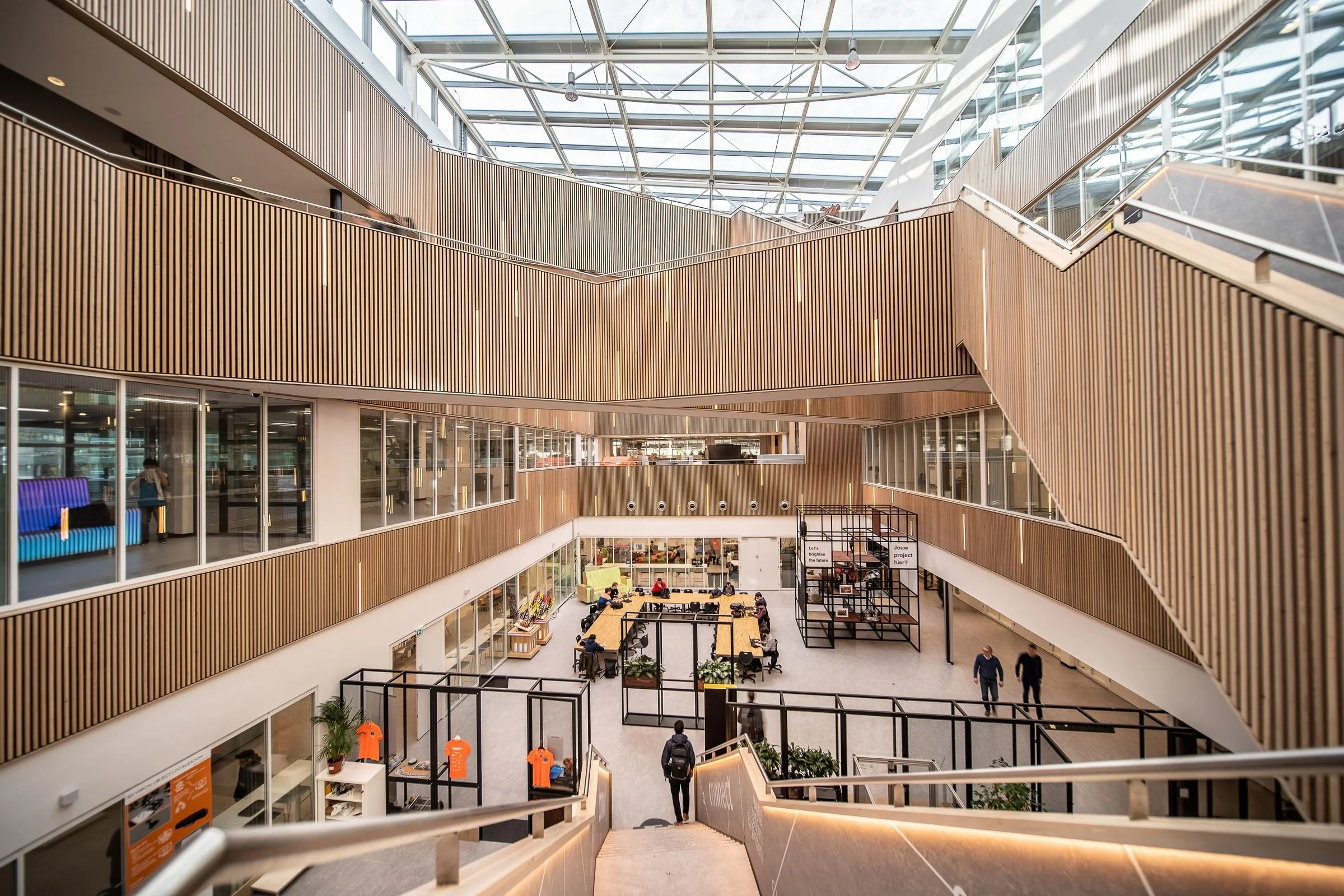 Atrium of a modern office building with timber-slatted balconies