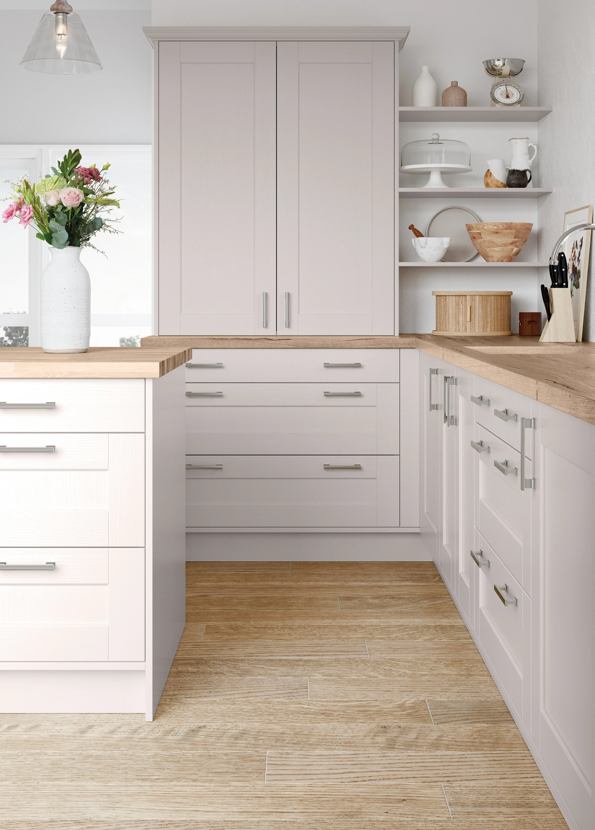 Bright white kitchen with wood countertops, paneled cabinets, open shelves, decorative dishware, a flower vase, and pendant lighting