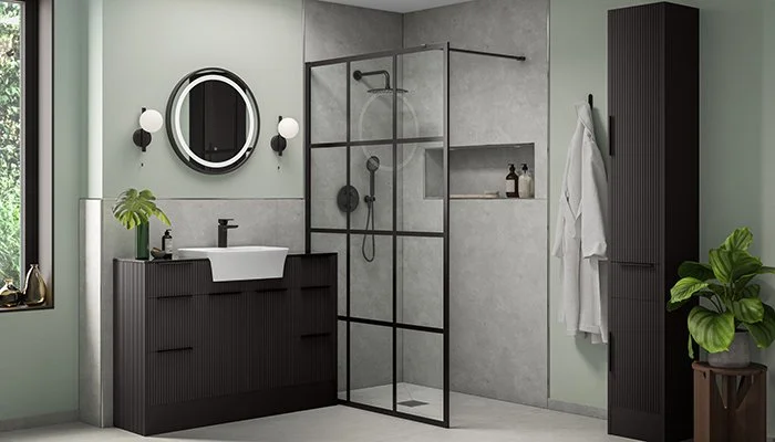 Modern dark wood bathroom vanity with round mirror, glass-enclosed walk-in shower, wall-mounted towel cabinet, and green plants