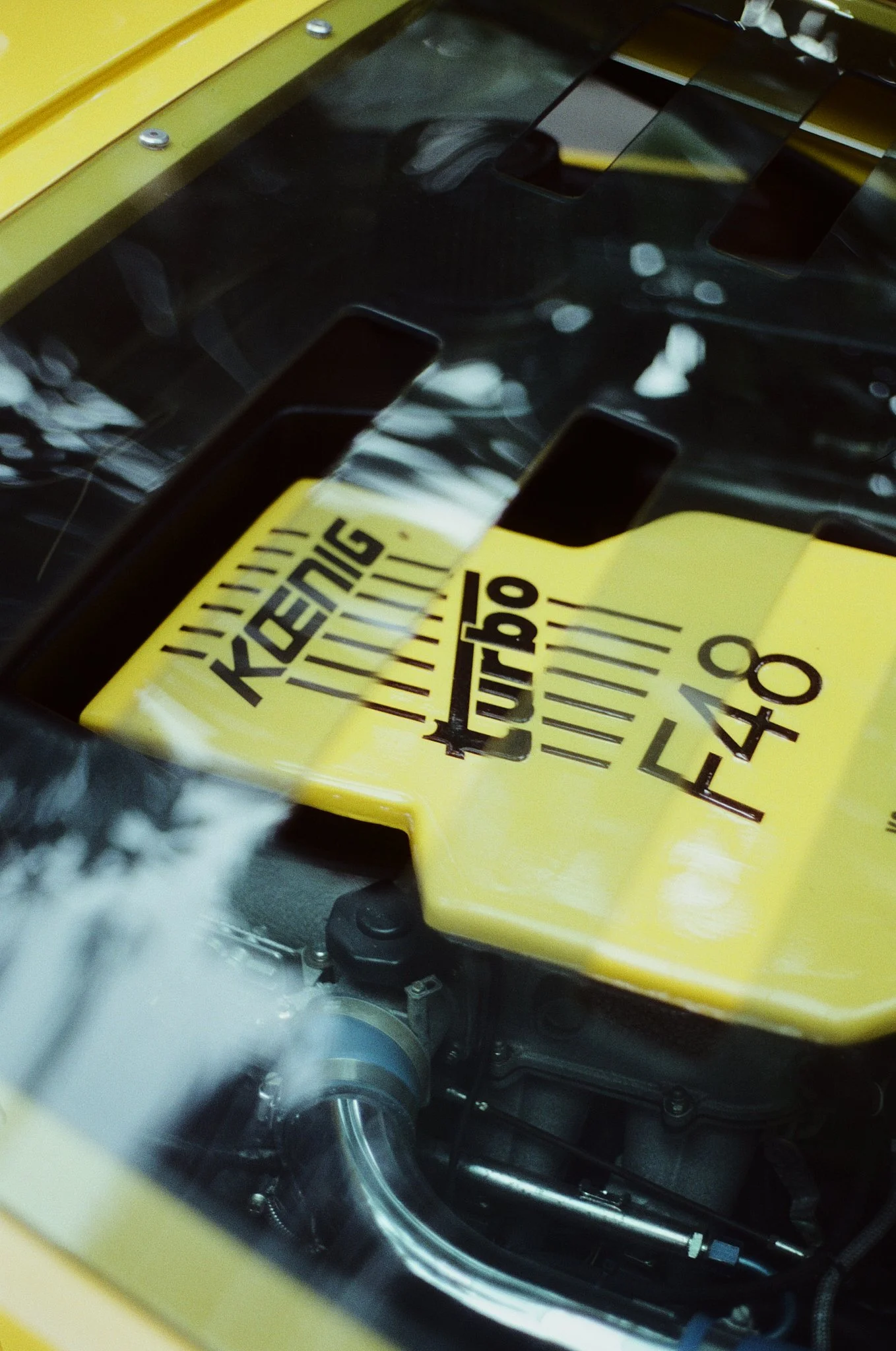Close-up view inside a laboratory machine showing a yellow and black label with the text 'KEYENCE' and some visible mechanical parts, including tubing and metal components.