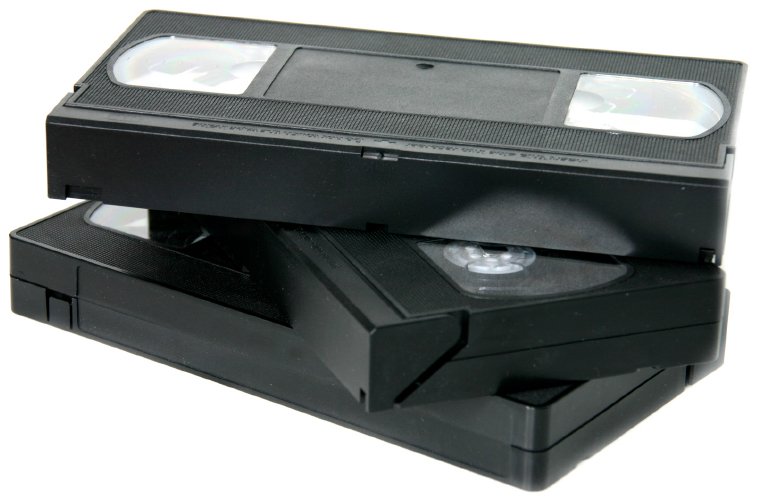 Three stacked VHS video cassette tapes.