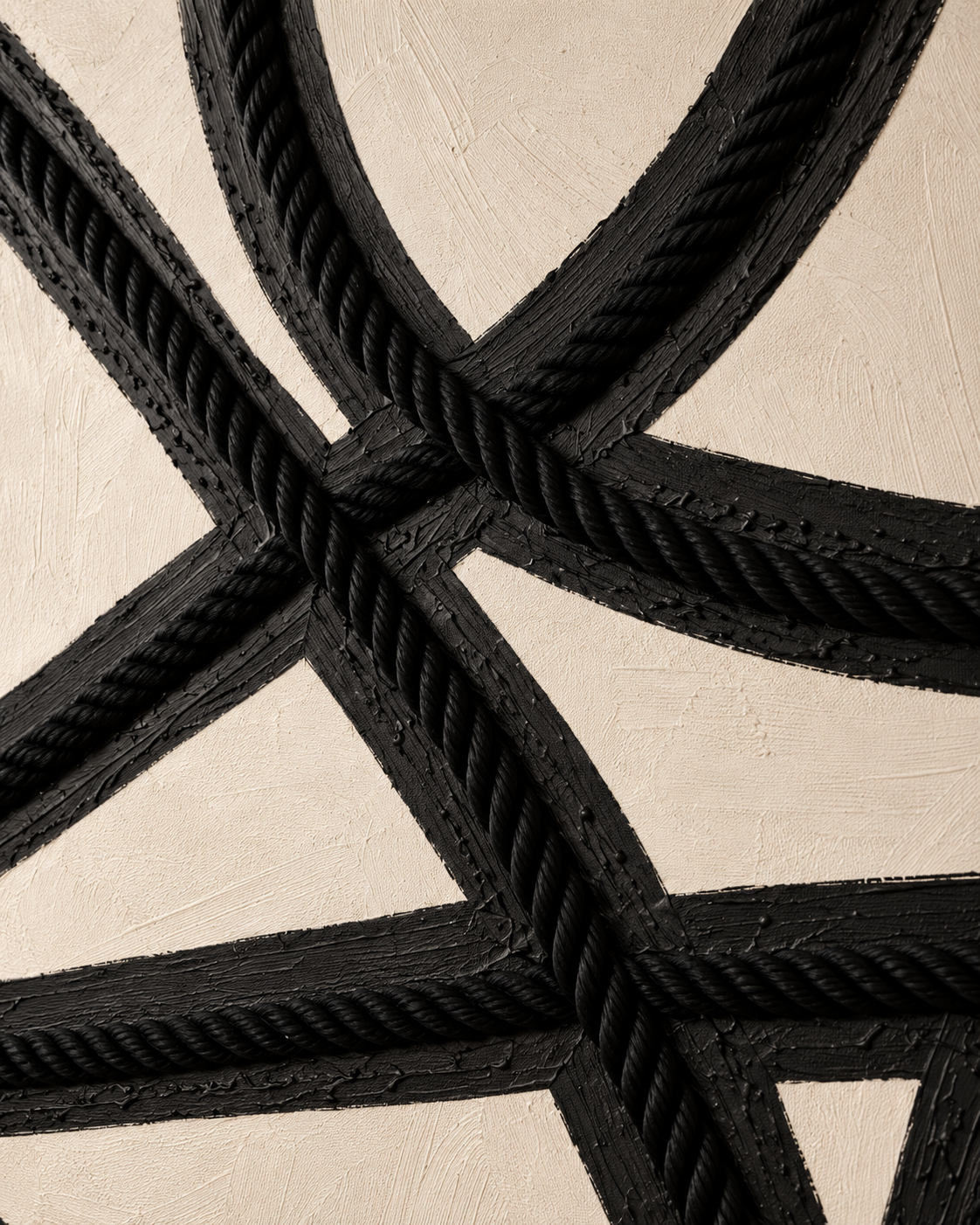 Close-up of thick black rope crossing over black wooden beams on a textured beige background