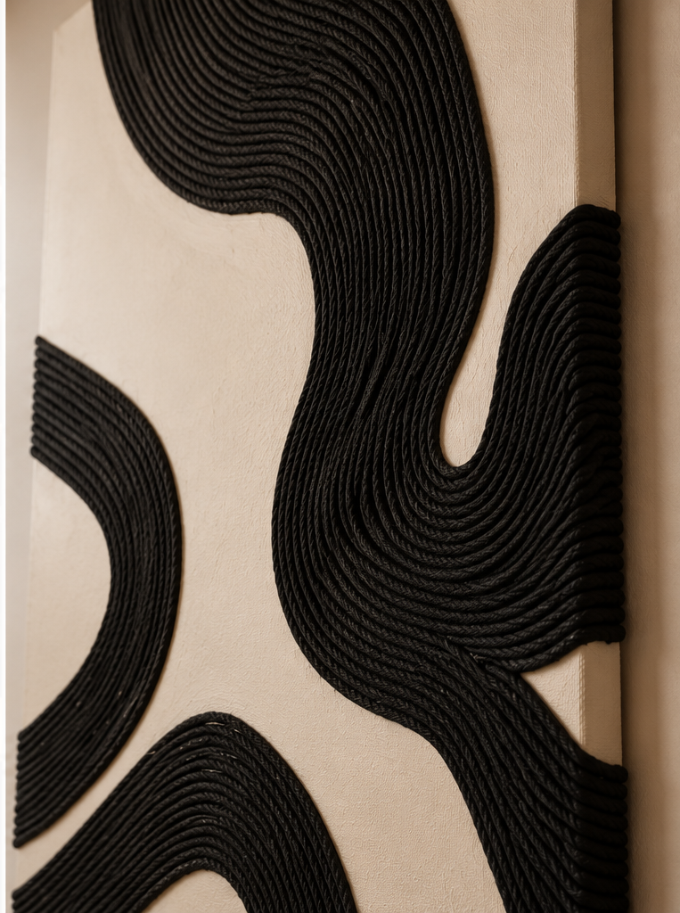 Abstract black braided rope wall art with flowing curved patterns on a beige background