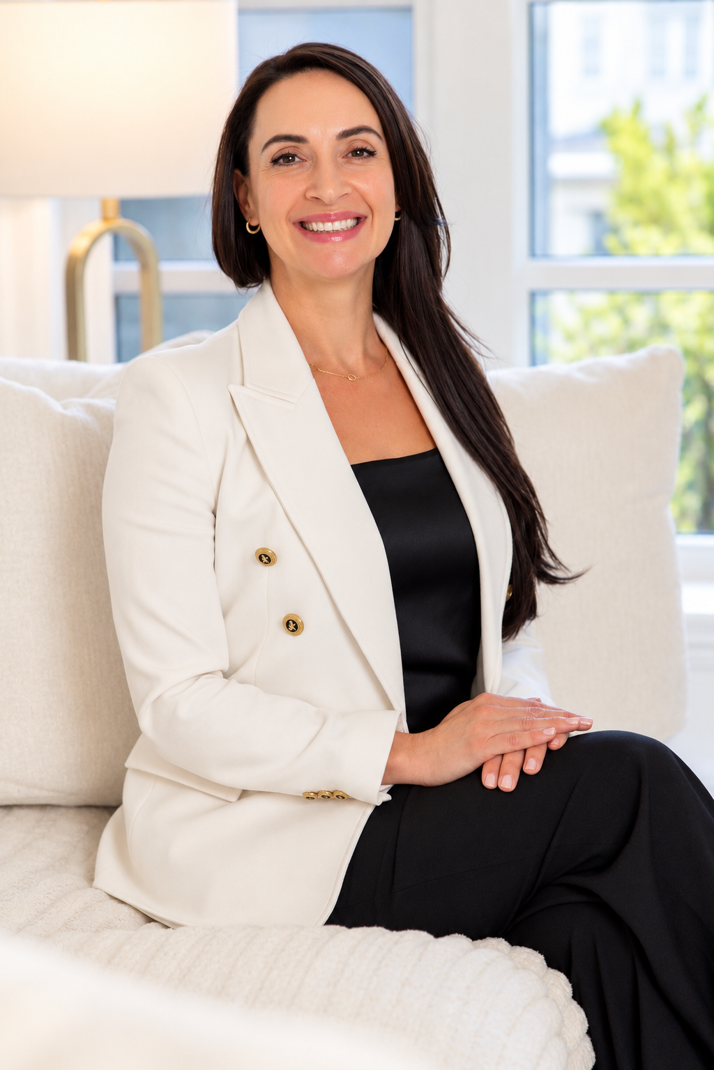 Dr. Oksana Gravets, registered Clinical Psychologist, seated in a bright room.
