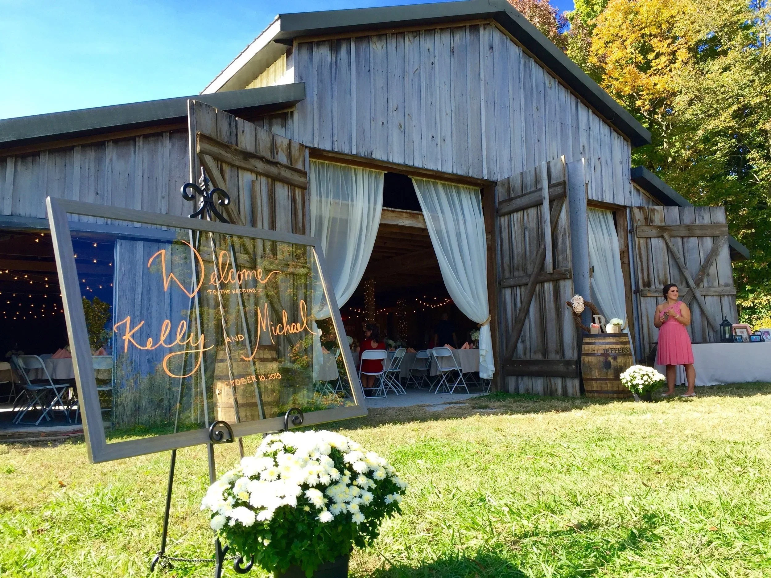 Floral welcome sign at the open barn entrance