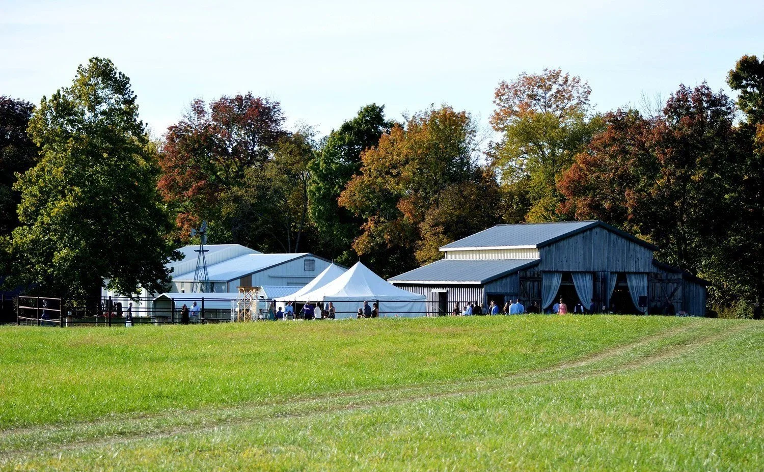 Tented event on the open lawn beside the barn