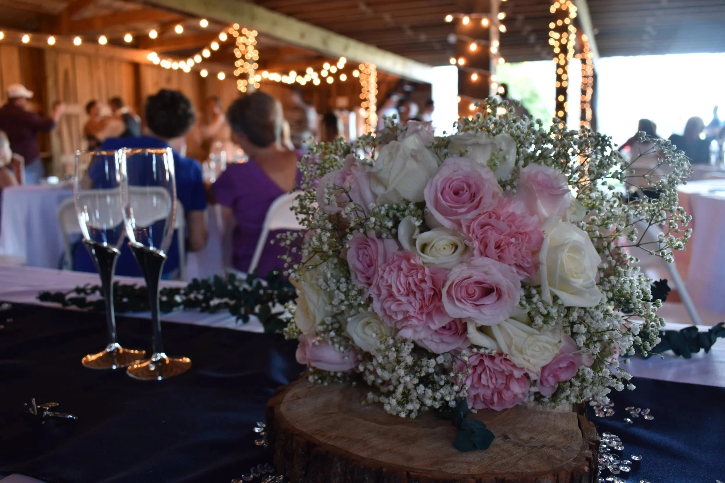 Pink peony and rose bouquet on a reception table