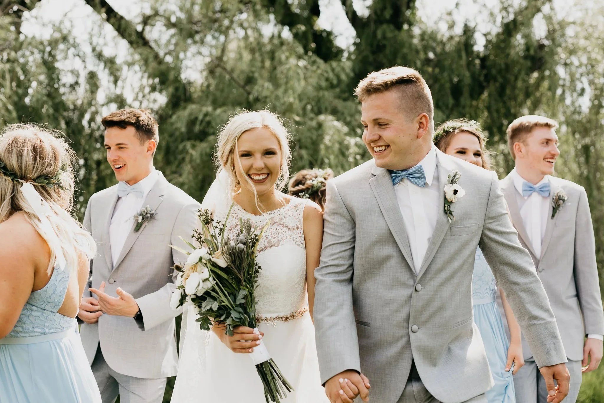 Smiling newlyweds walking back up the aisle after the ceremony