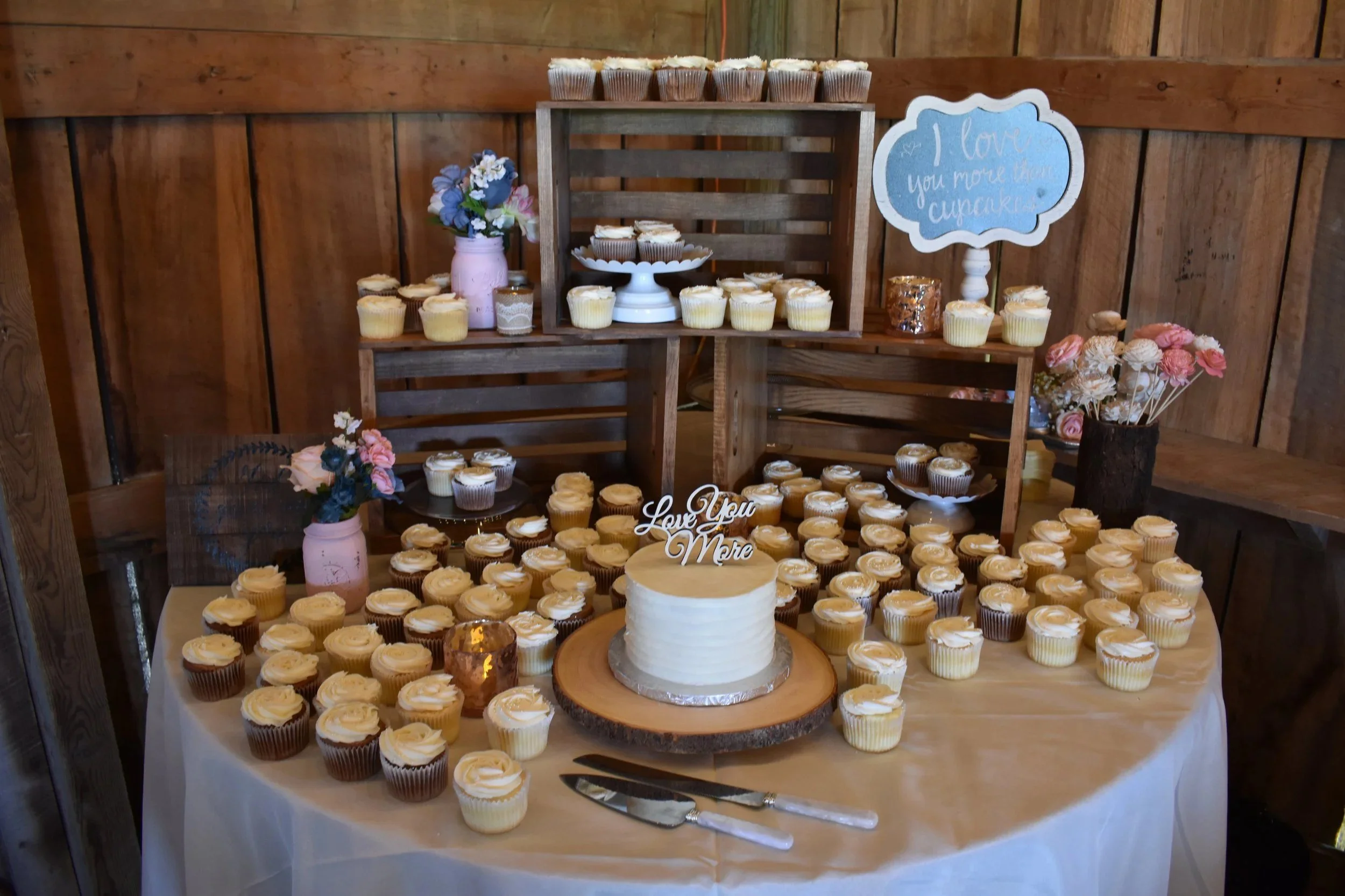 Cupcake and cake dessert table on rustic crates