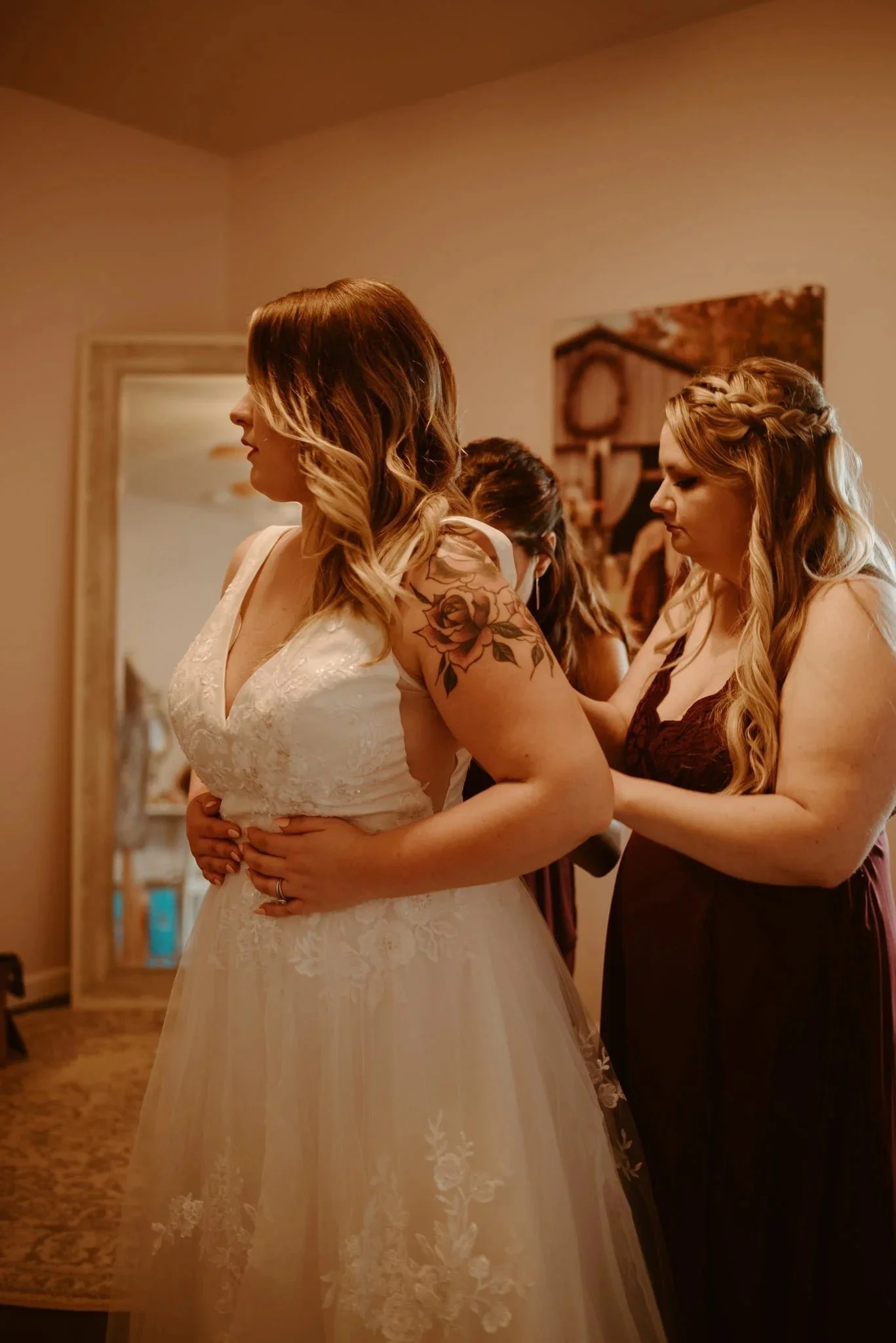 Bride getting ready with her bridesmaid in the bridal suite