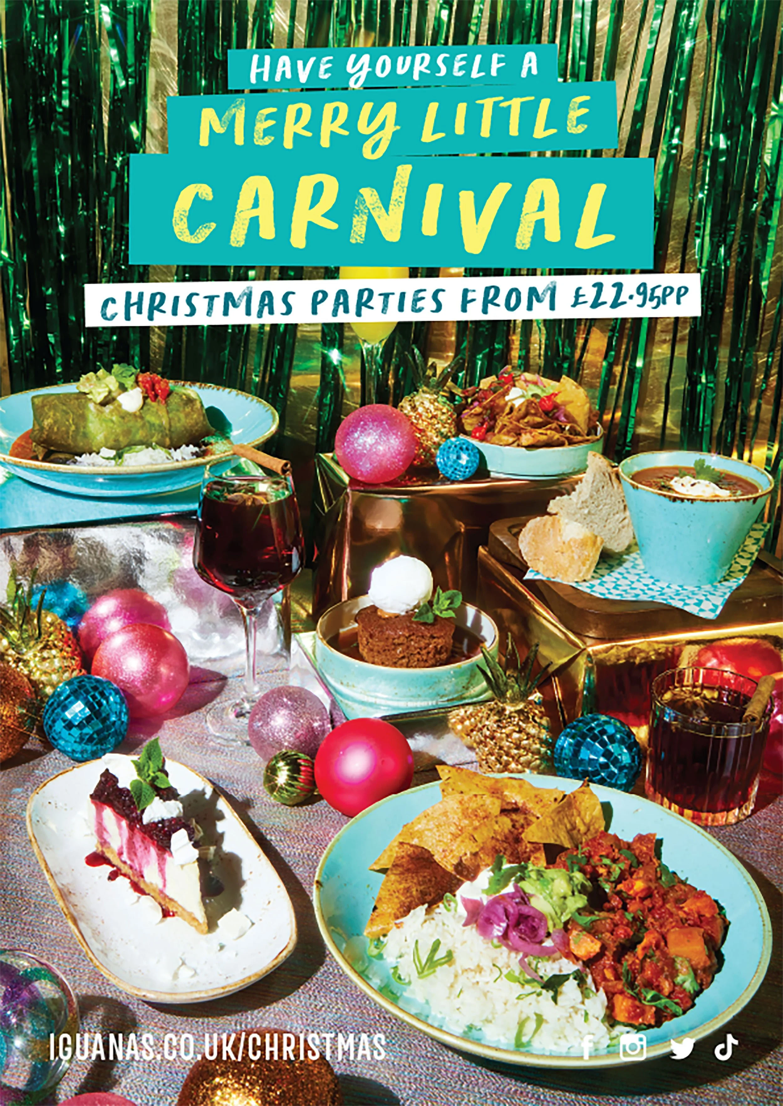 Festive Christmas dinner table with colorful ornaments, assorted dishes and desserts, and a sign reading “Have Yourself a Merry Little Carnival.”