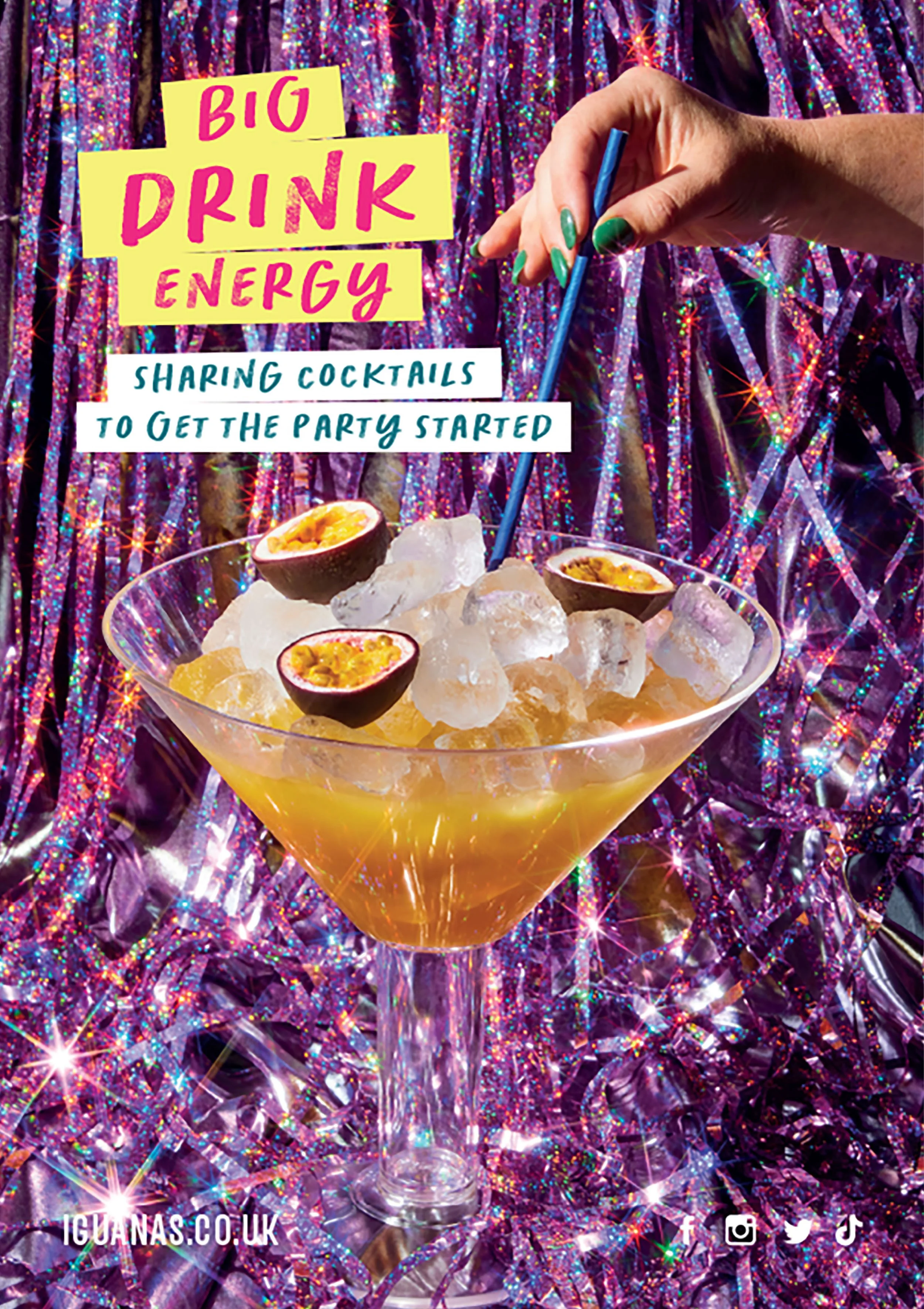 Colorful passion fruit cocktails with ice, a blue straw, and party-themed signs reading “BIG DRINK ENERGY” against a glittery backdrop.