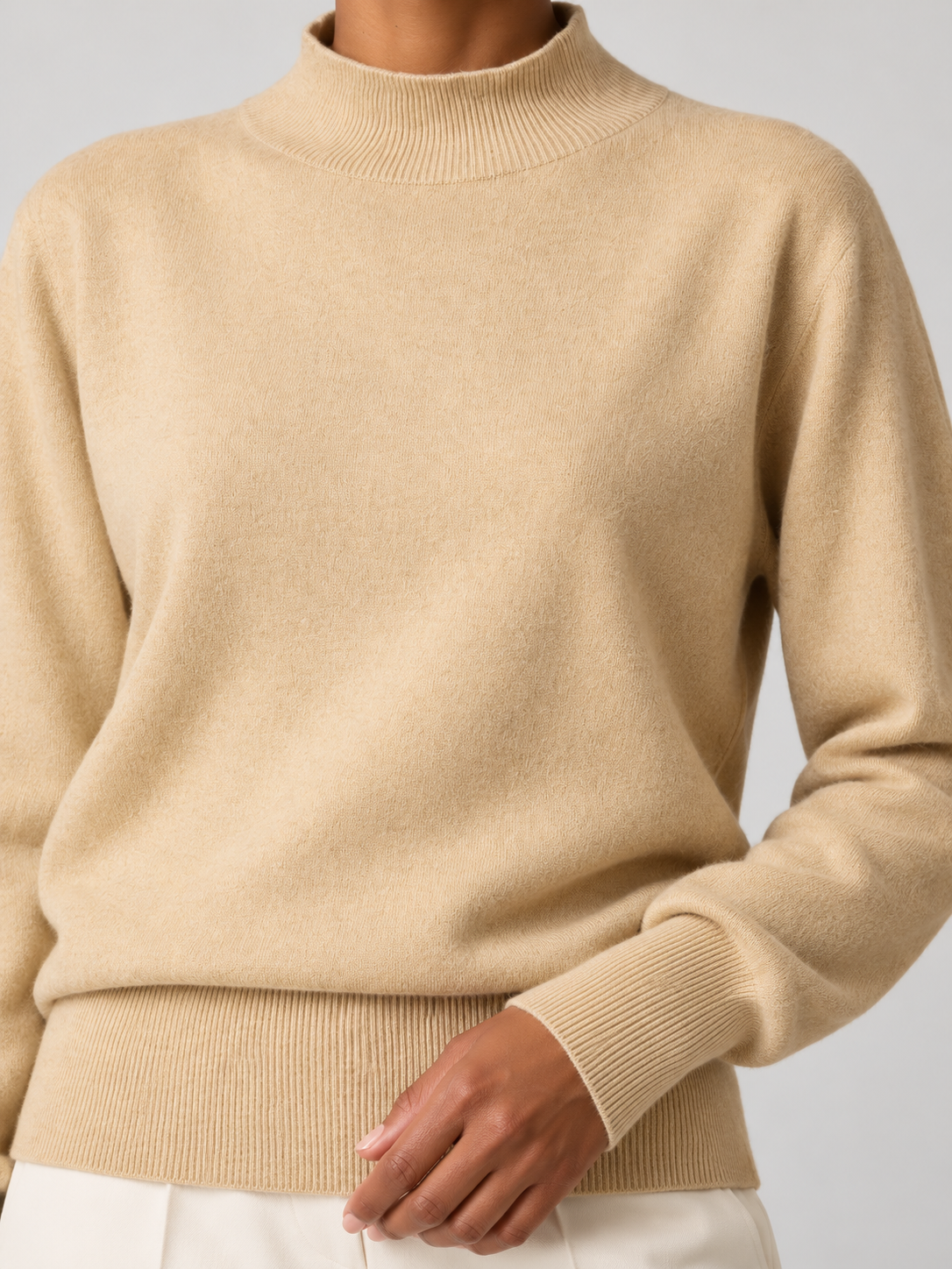 Close-up beige mock-neck sweater detail.png