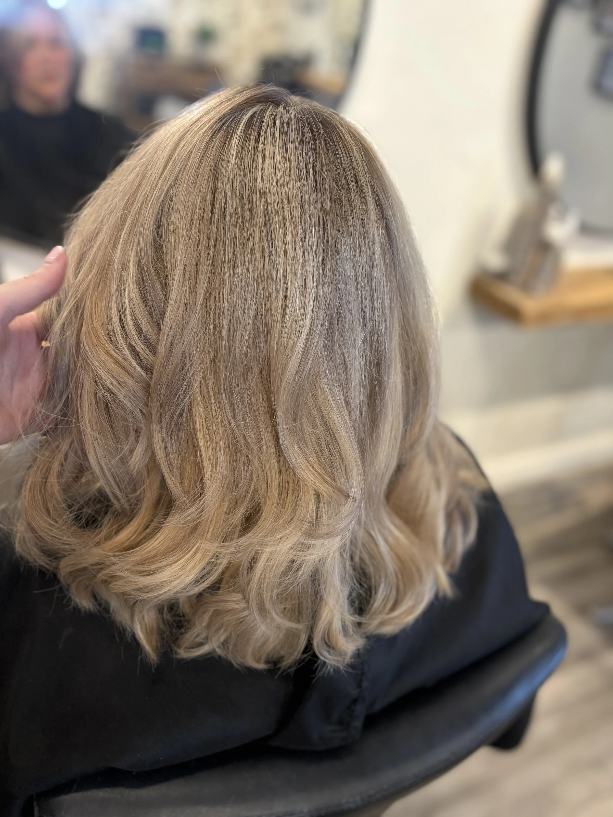 Full head of highlights, a layered cut and styled with a slight bend