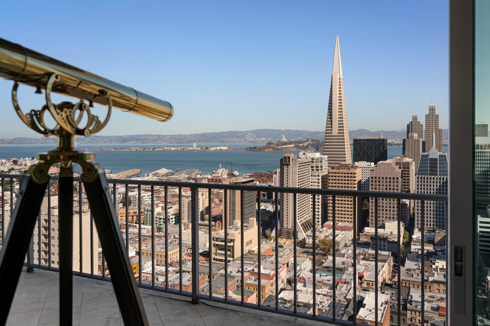 City skyline with the Transamerica Pyramid building in San Francisco view from a balcony with a telescope.