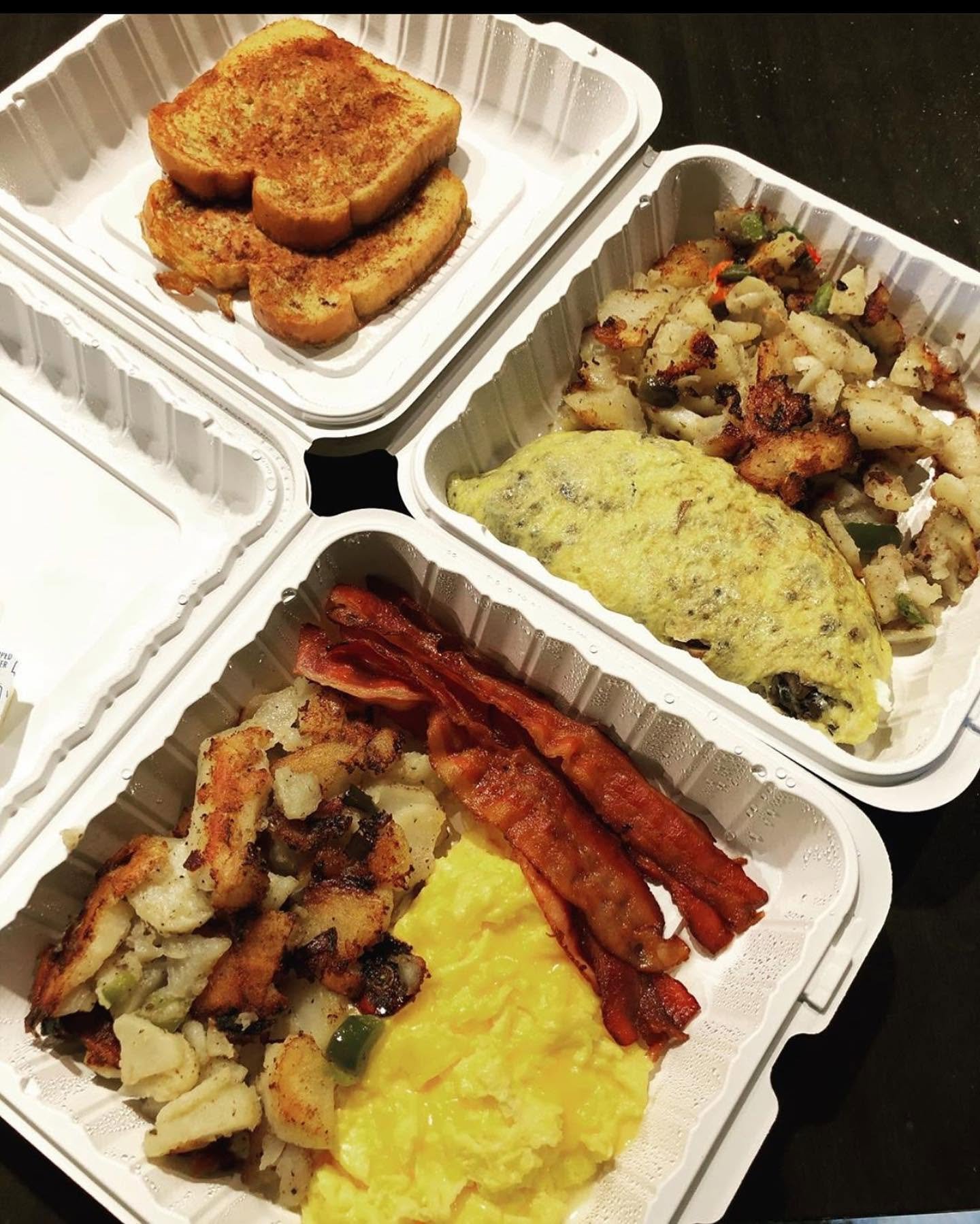 Three takeout containers filled with breakfast foods: toasted bread, scrambled eggs, hash browns, crispy bacon, and fried potatoes with vegetables.