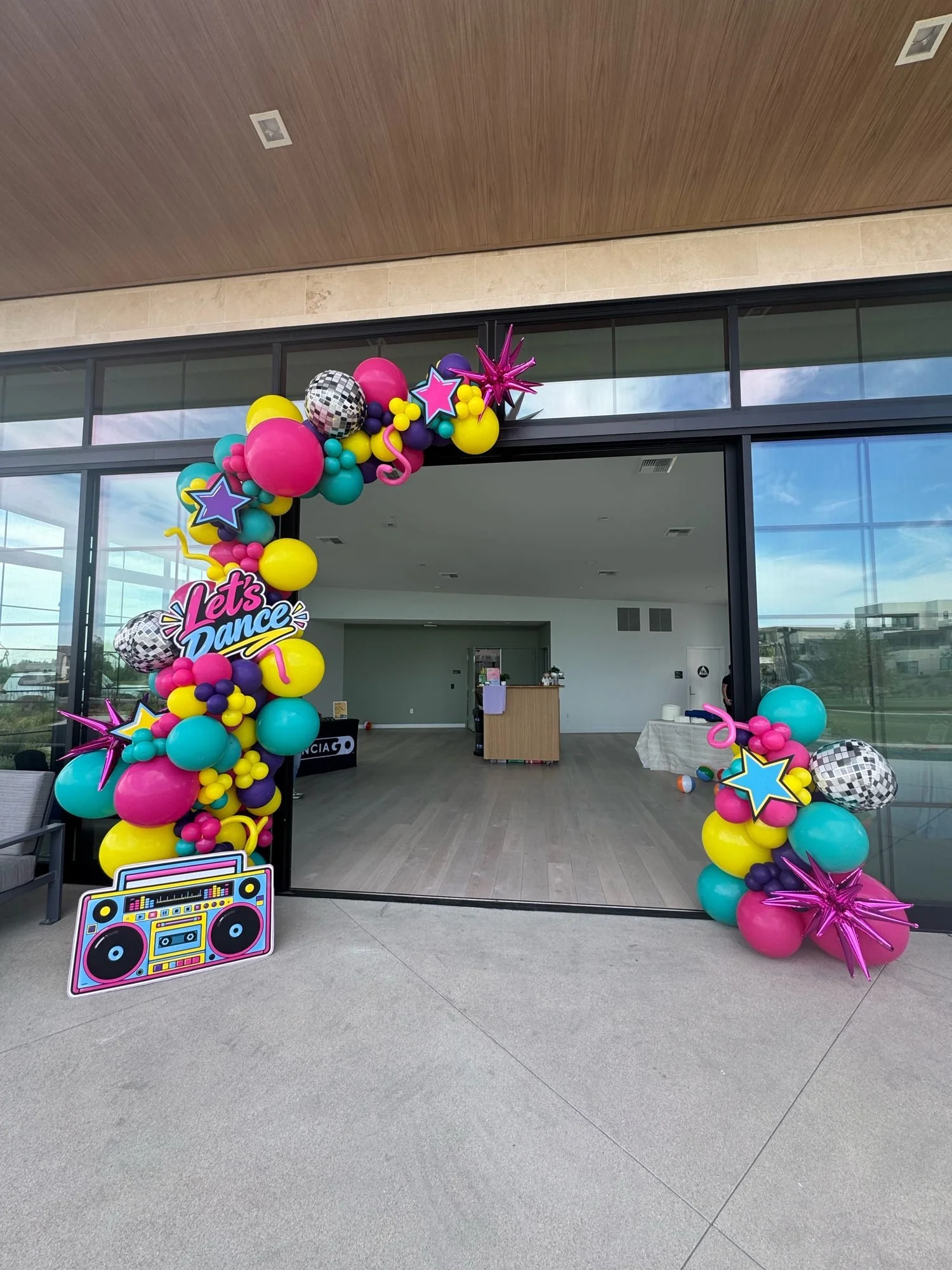 Colorful balloon entrance arch for a 90s dance party