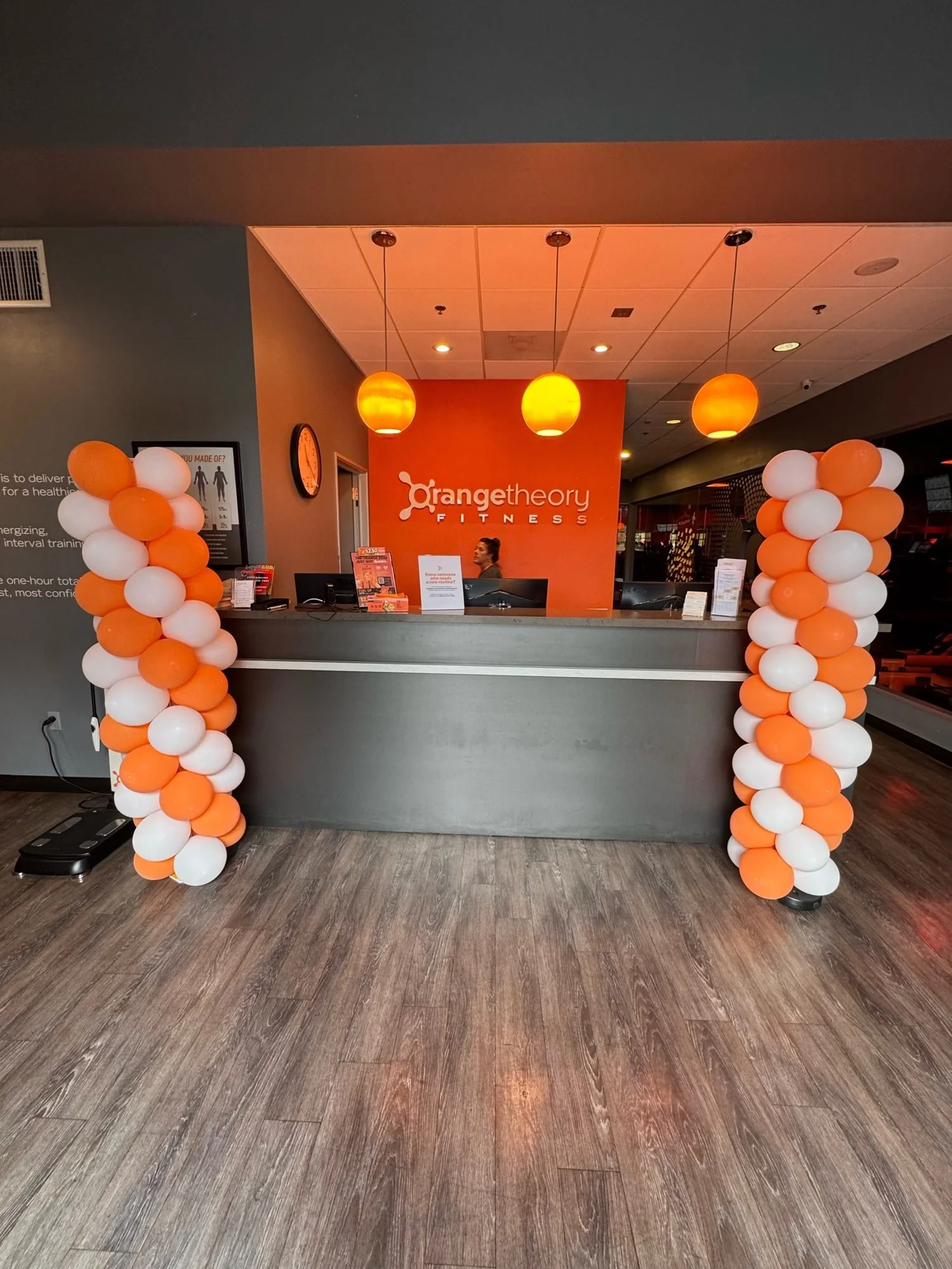 Orange and white balloon columns at a studio event
