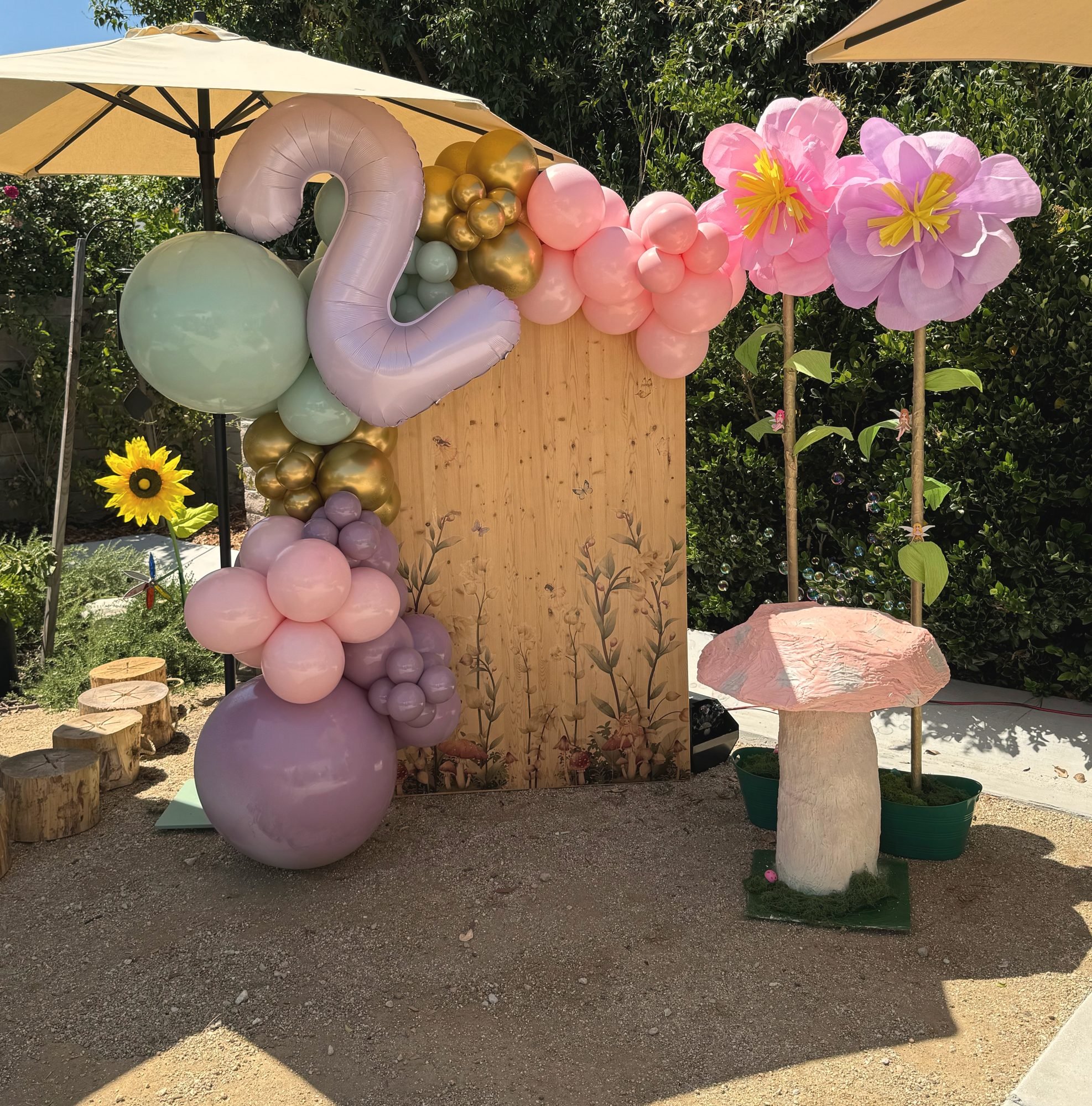 Fairy garden 2nd birthday backdrop with balloons and giant paper flowers
