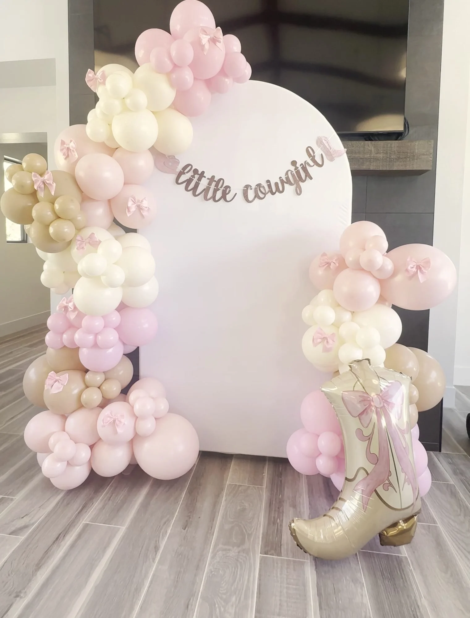Little cowgirl balloon arch in pink, cream and tan