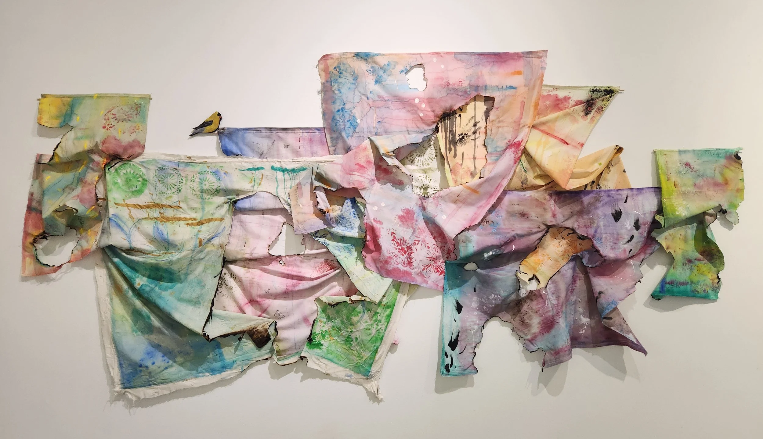 “Burned to Unveiling”
March 2026
Fabric, Acrylic Paint, Watercolor, Wax, Sharpie, & Puffy Paint
120” x 48”