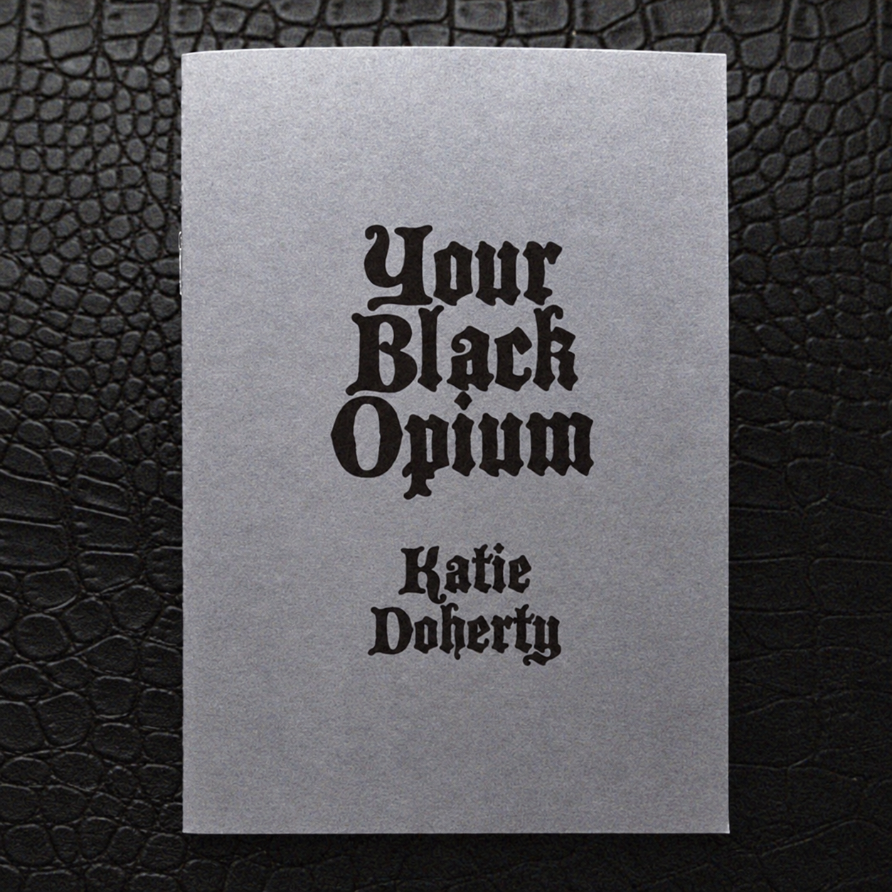 Grey Blackletter Chapbook on Textured Leather.png