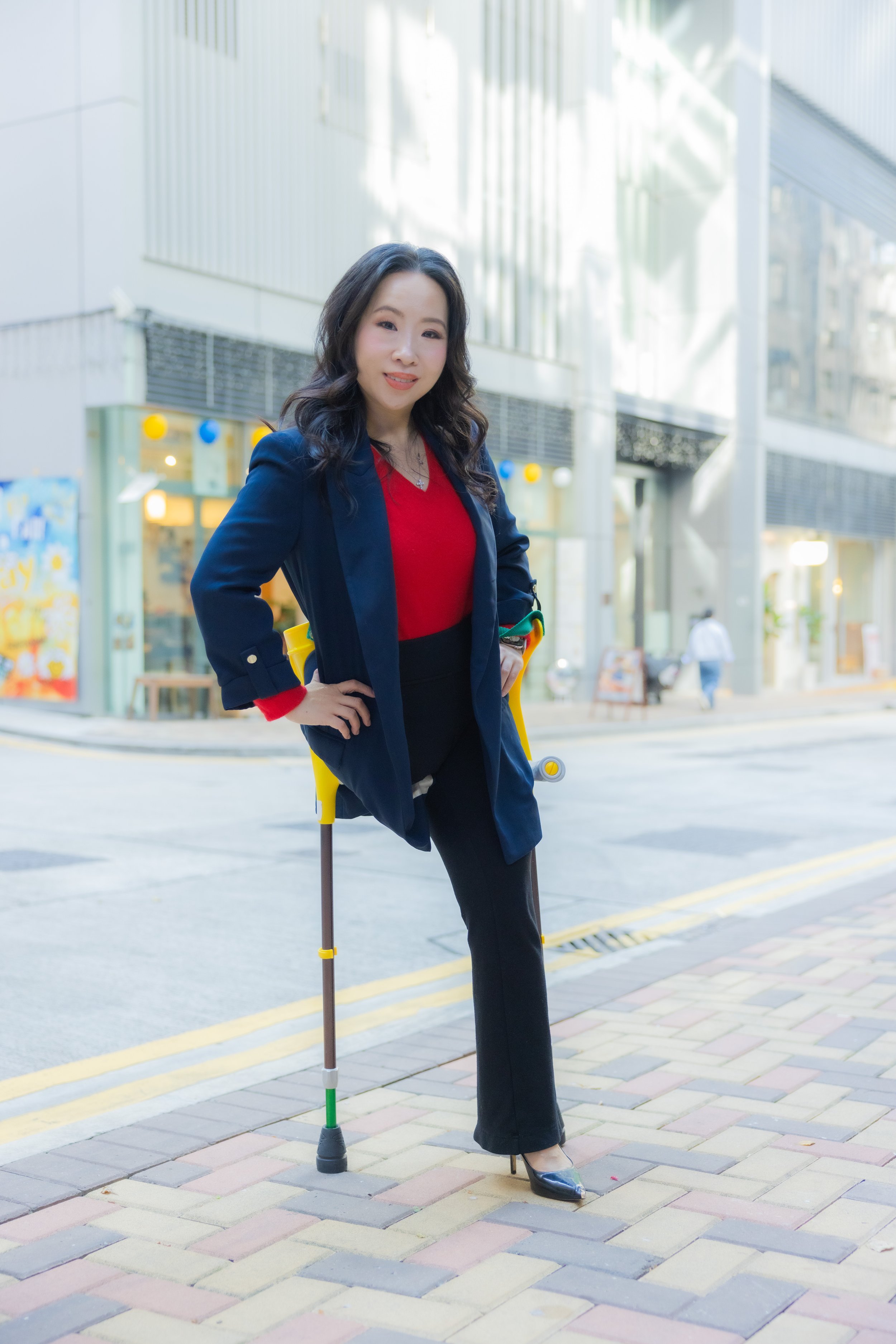 Businesswoman using a white cane while walking through a bright modern building