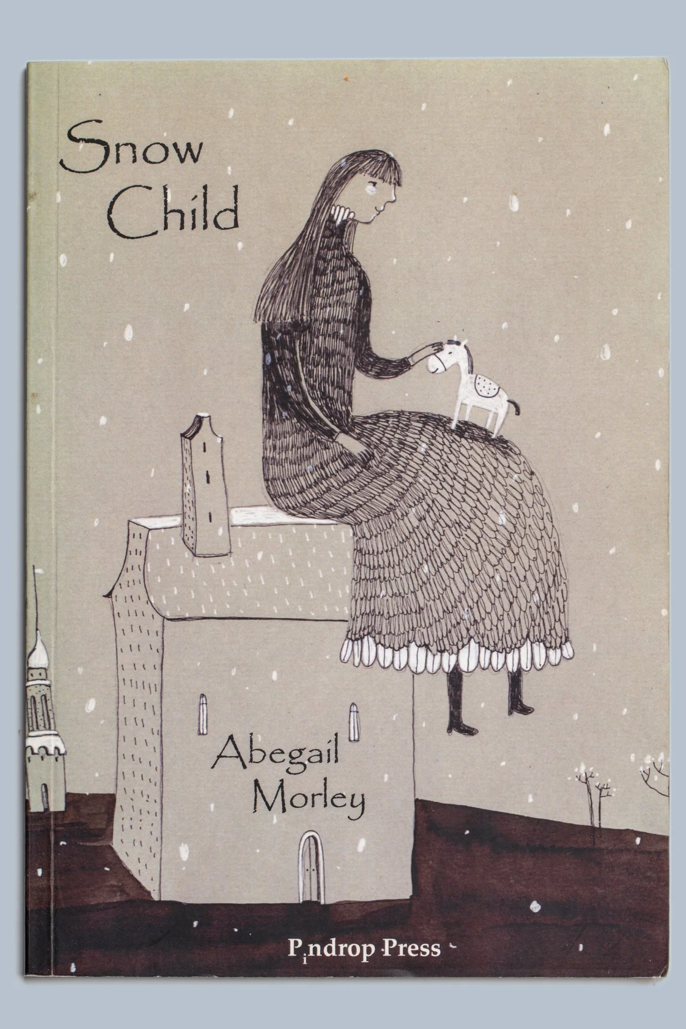 Cover of the children's book Snow Child by Abigail Morley, featuring a girl holding a small white horse in falling snow.