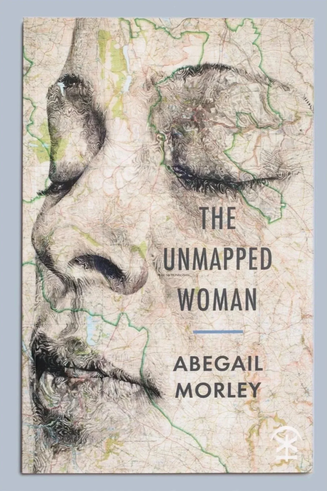 Book cover for The Unmapped Woman by Abegail Morley, featuring a topographic map with mountain contours.