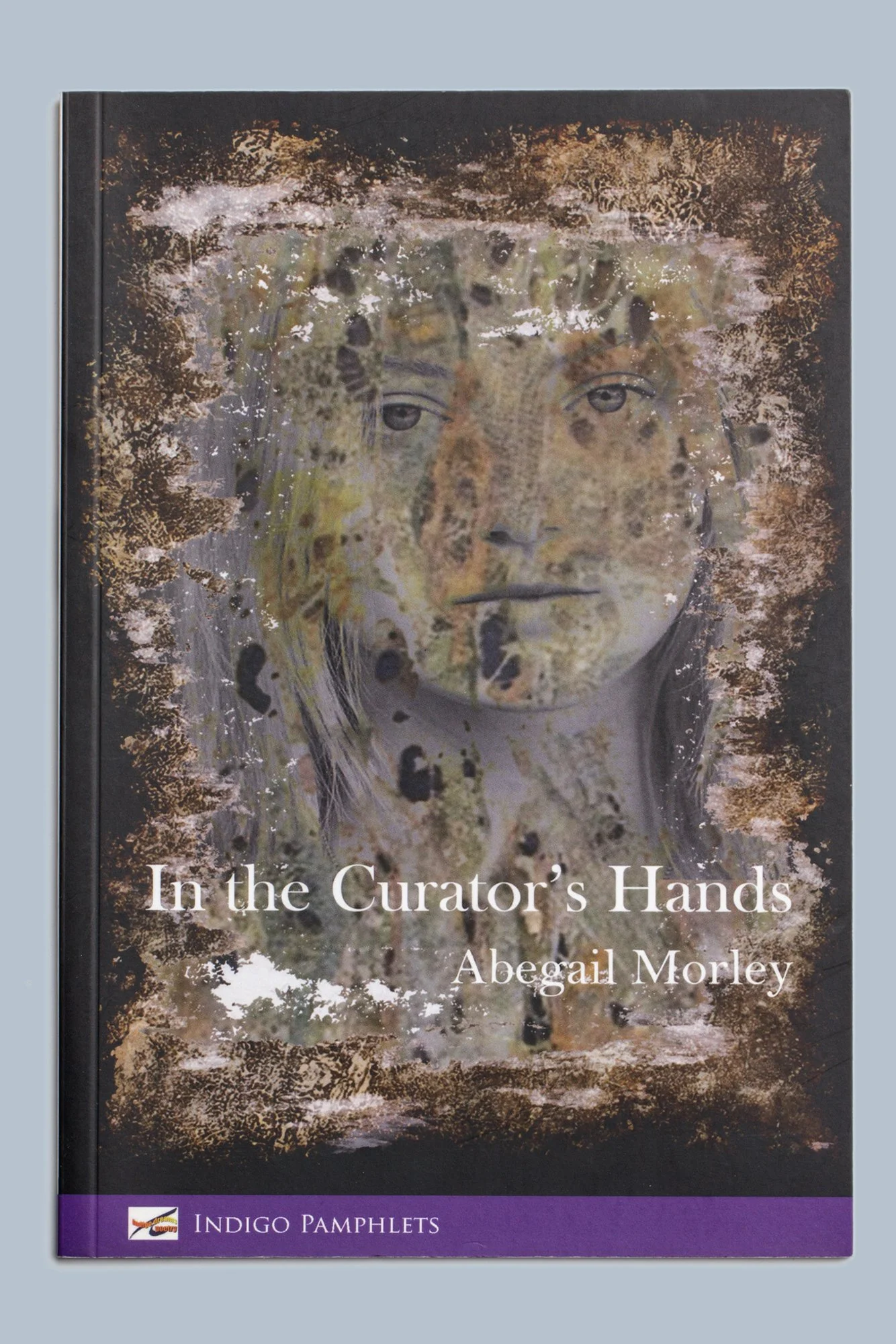 Book cover of Abigail Morley’s “In the Curator’s Hands,” featuring a weathered portrait and purple Indigo Pamphlets banner.