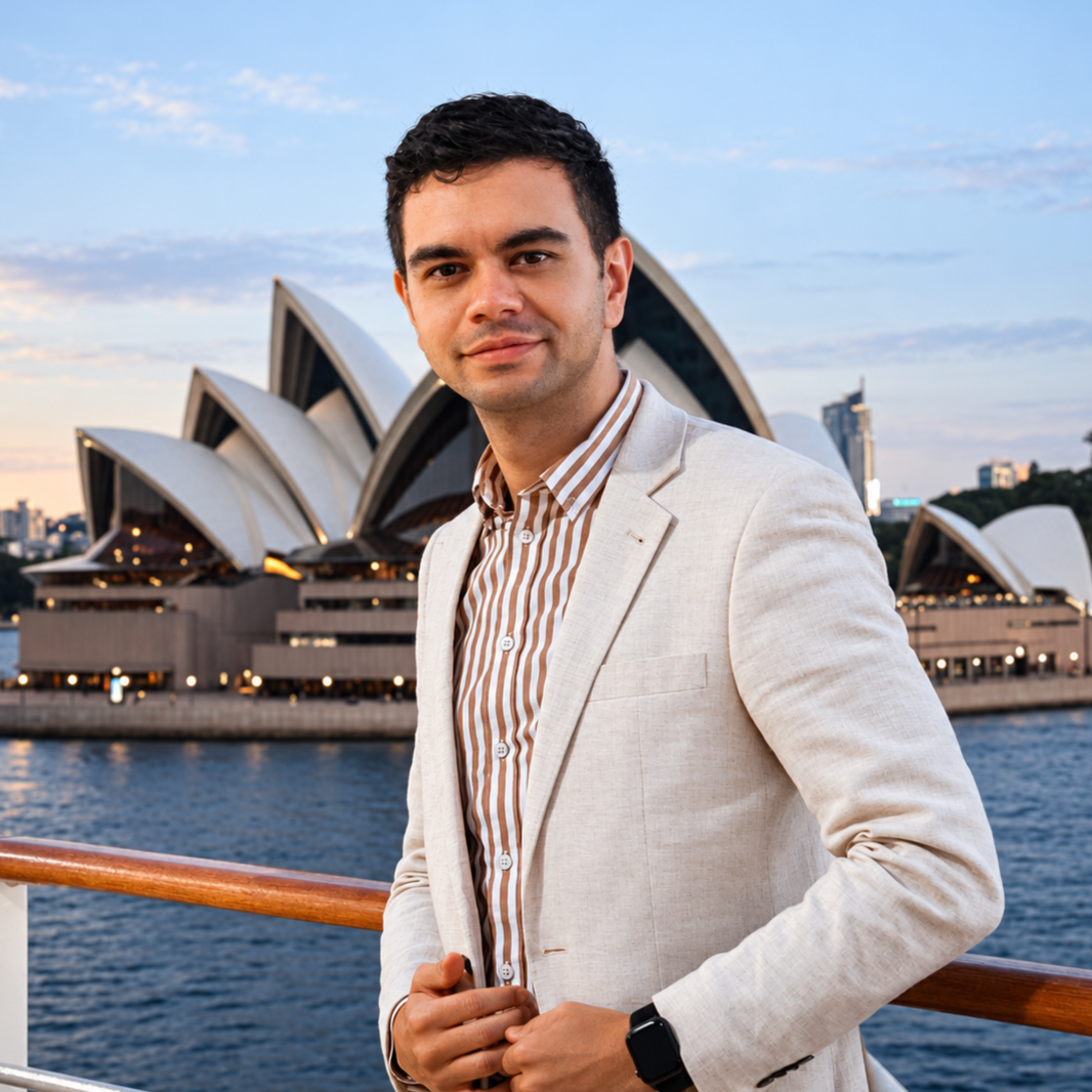 Zak Widuss standing on a cruise ship with the Sydney Opera House in the background.