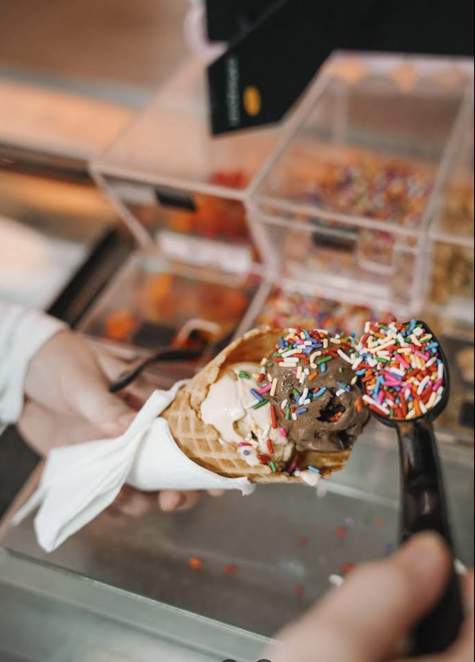 Scooping an ice cream cone with toppings