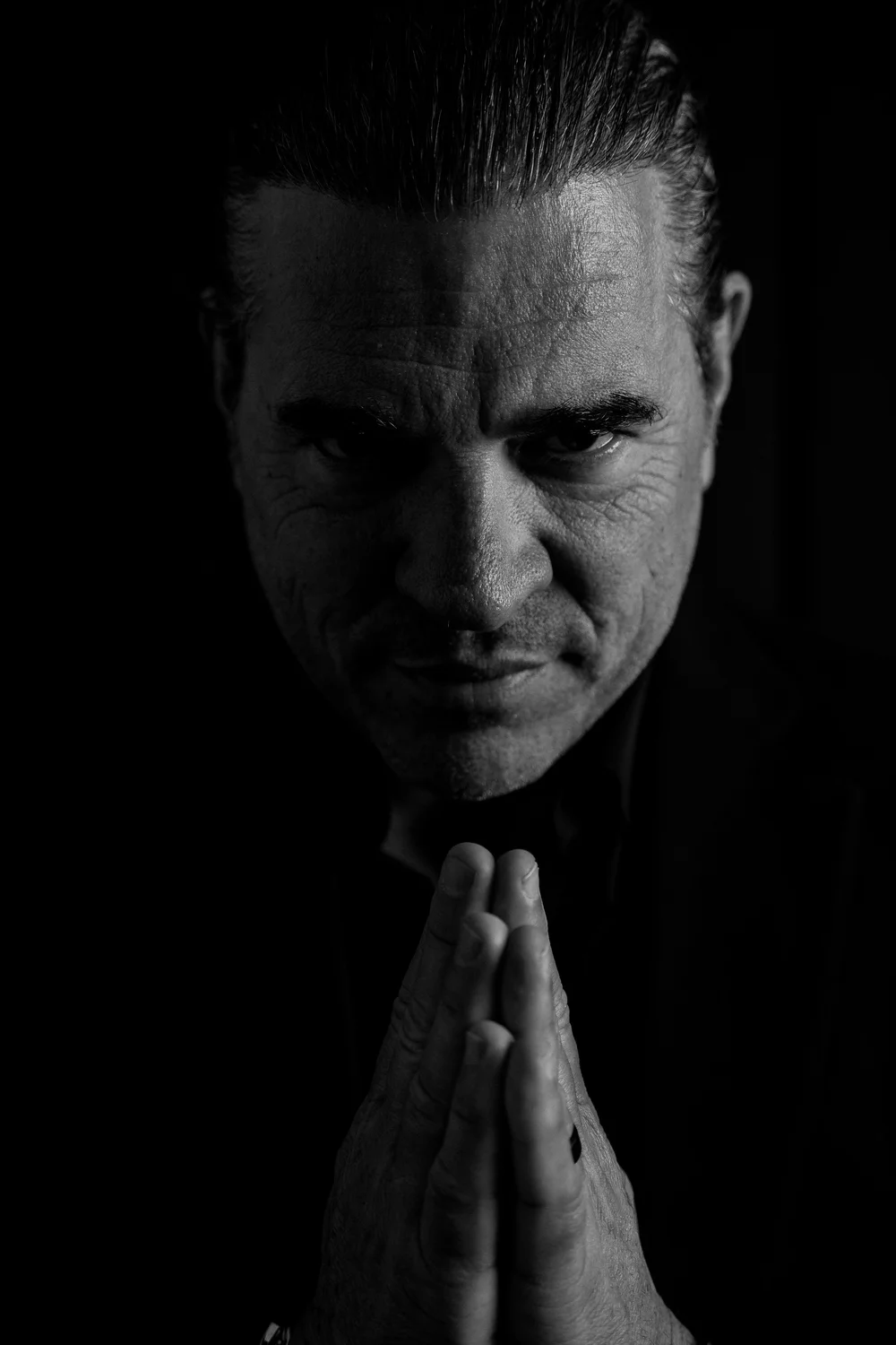 Dr. Ramsey, hands pressed together, black and white portrait