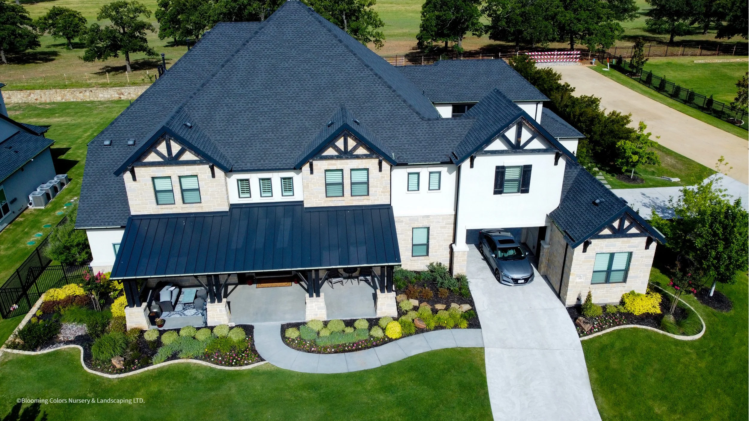 Aerial view of a two-story home with landscaped front yard in Southlake TX