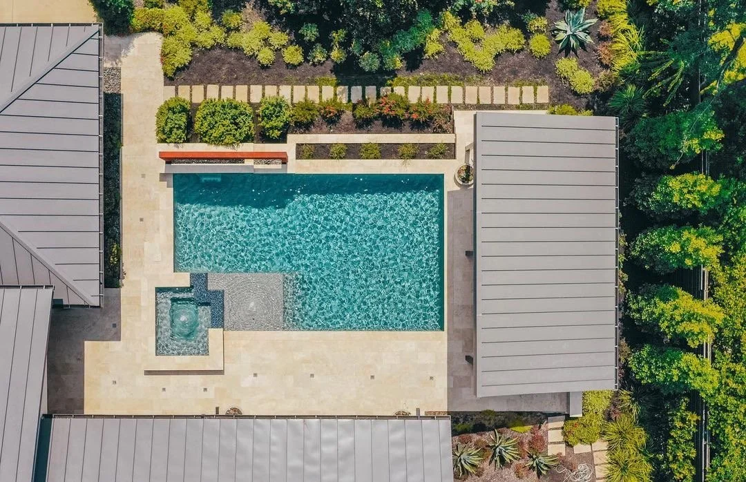 Aerial view of a backyard pool with stone patio and landscaping in Southlake TX