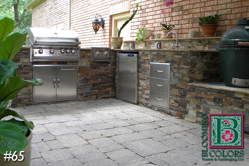 Stainless grill and stone counter with ceramic cooker in an outdoor kitchen