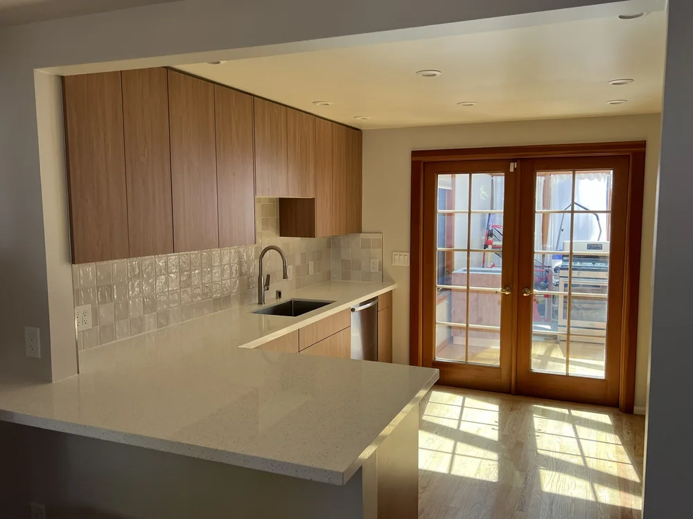 Finished kitchen remodel with wood cabinetry and French doors