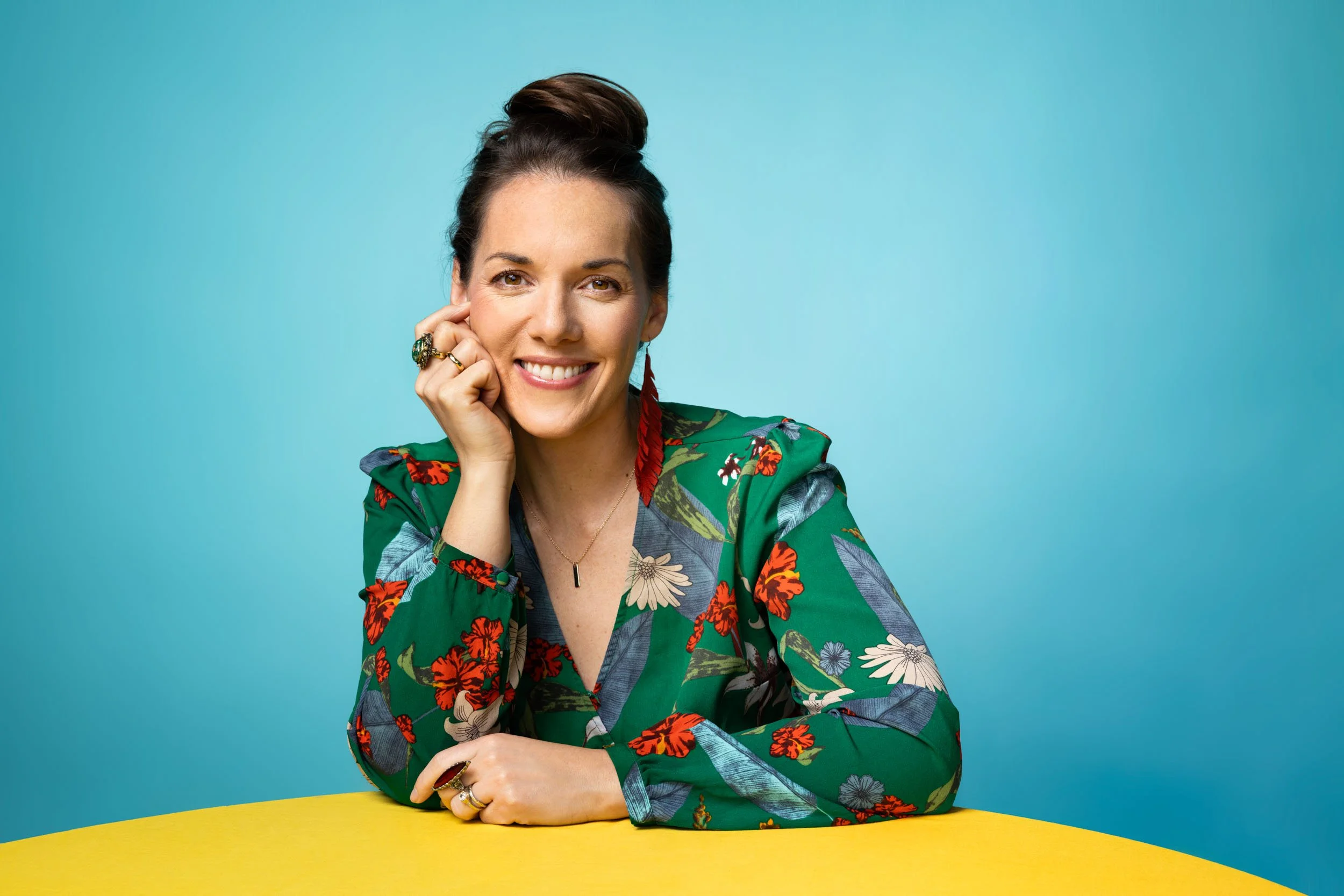 Maria Finkelmeier at a yellow table smiling