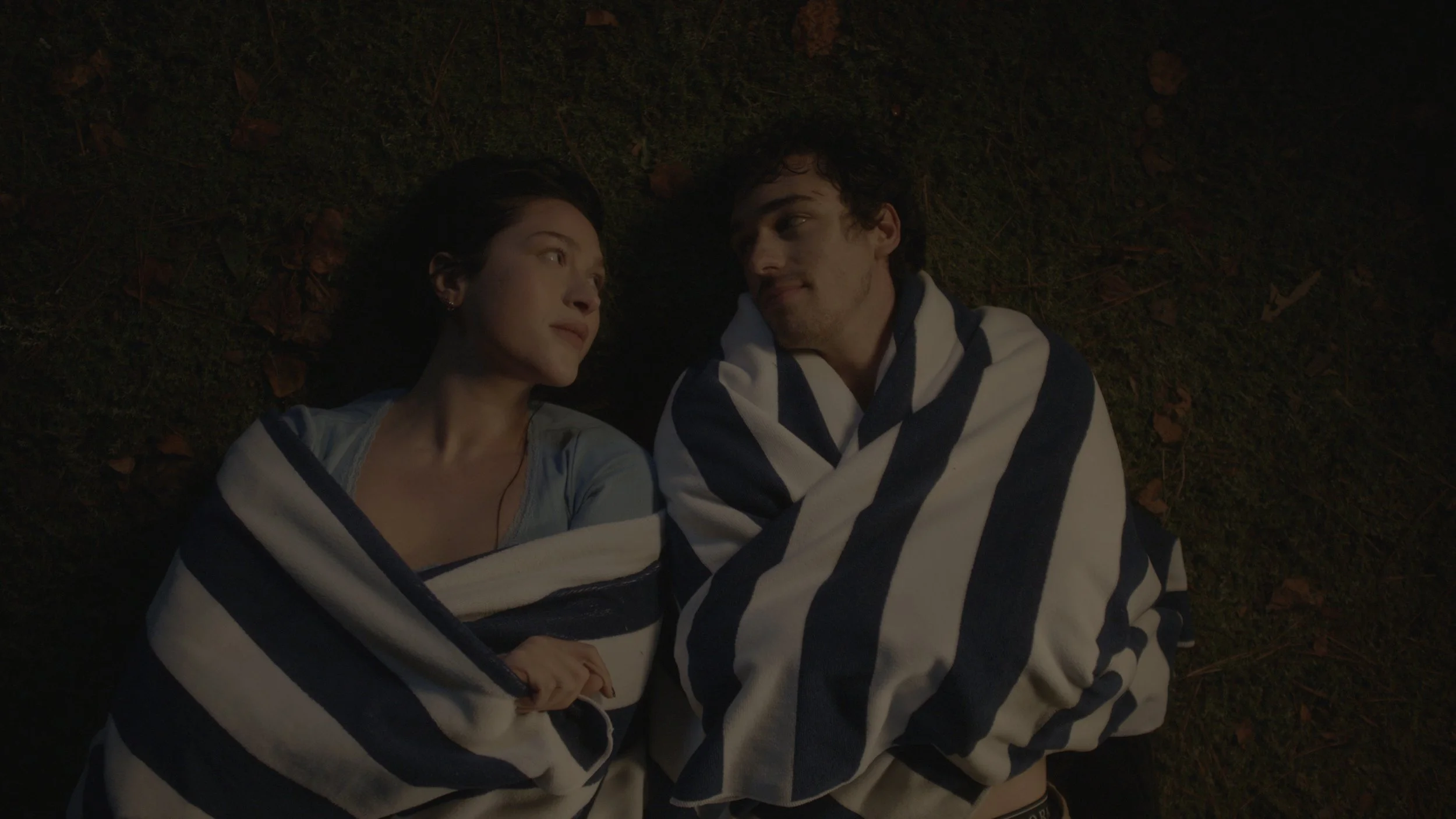 Boy and girl wrapped in blue and white towel