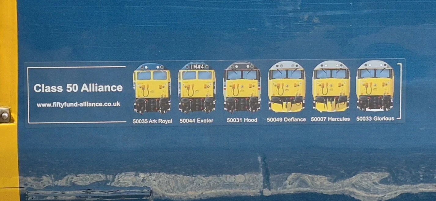 Sticker of six yellow Class 50 locomotives from the UK, each with a name and number, displayed in a row with labels: Ark Royal, Exeter, Hood, Defiance, Hercules, and Glorious.