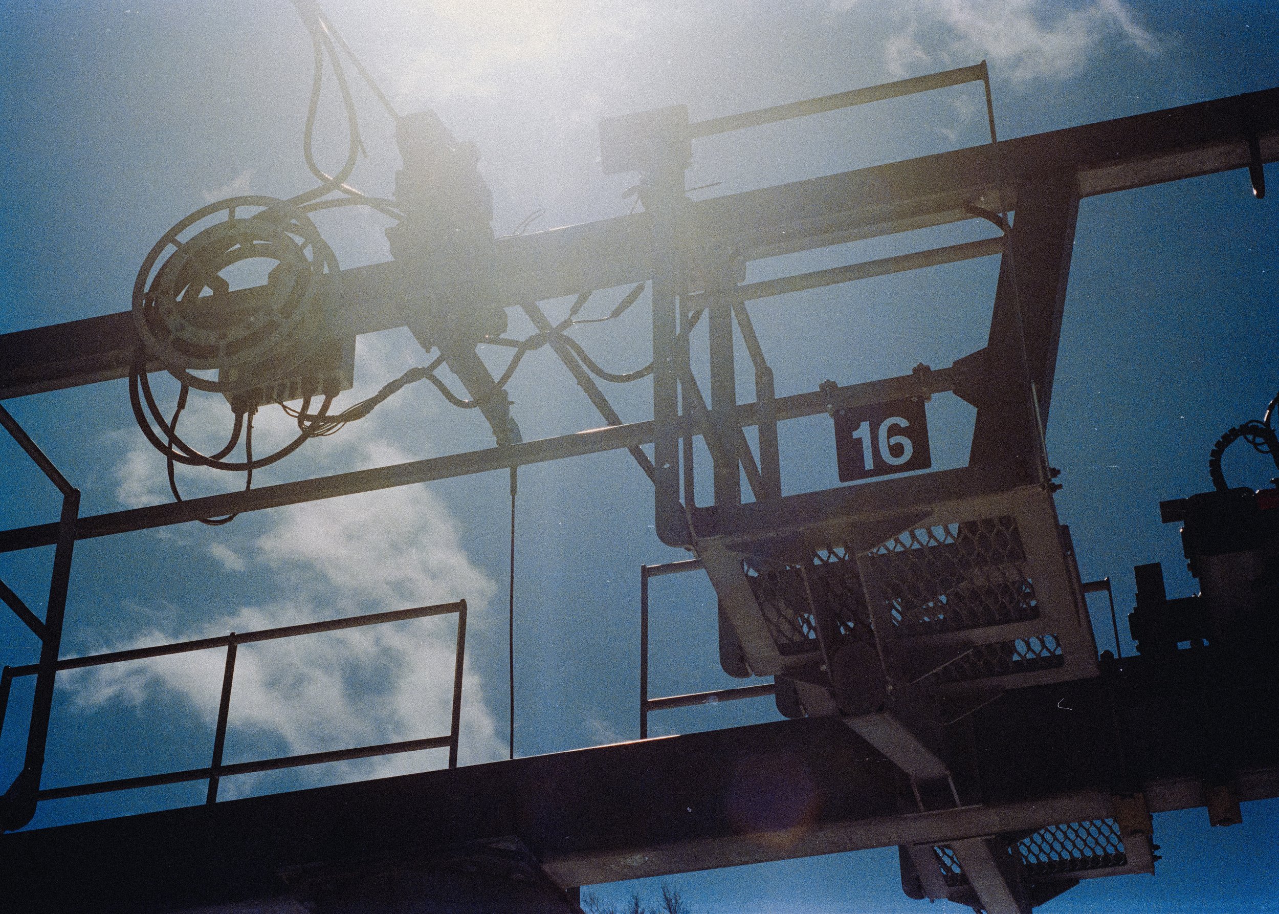 35mm Film Photo of Ski Lift Pole with sun beaming through, number 16 at sugar loaf mountain