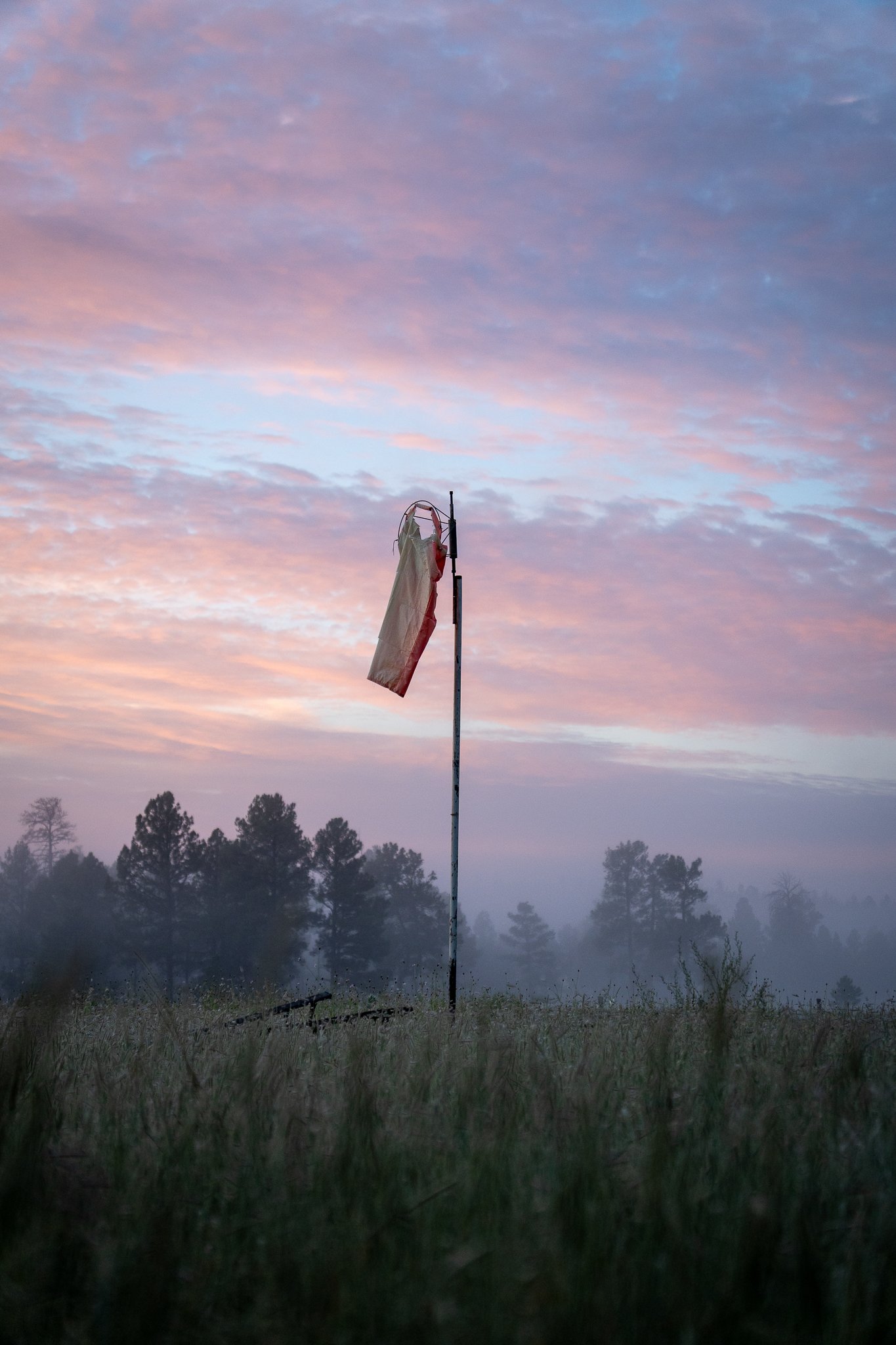 A windsock in front of a beautiful sunrise