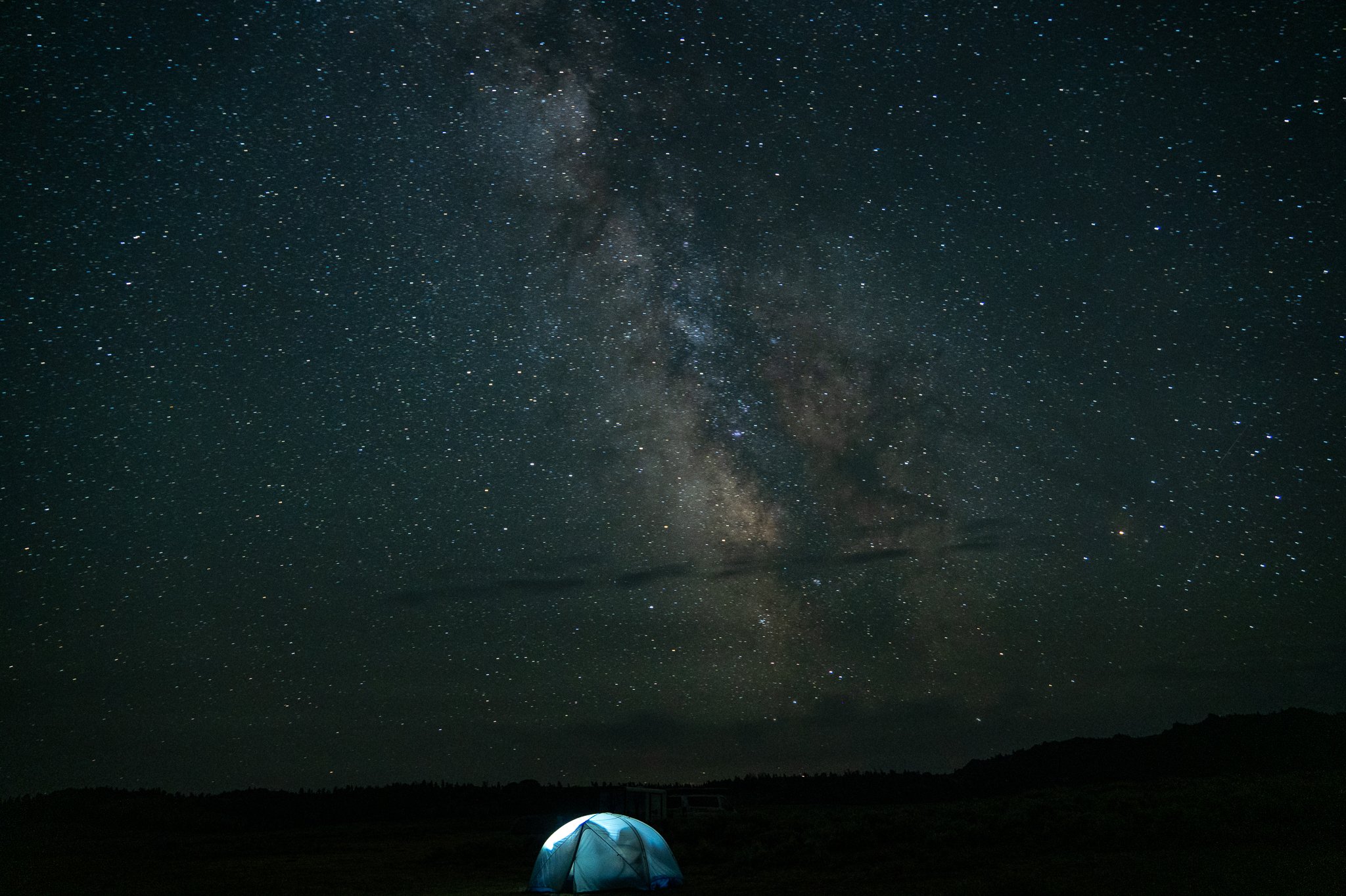 Night shot of the Milky Way with a glowing tent under it
